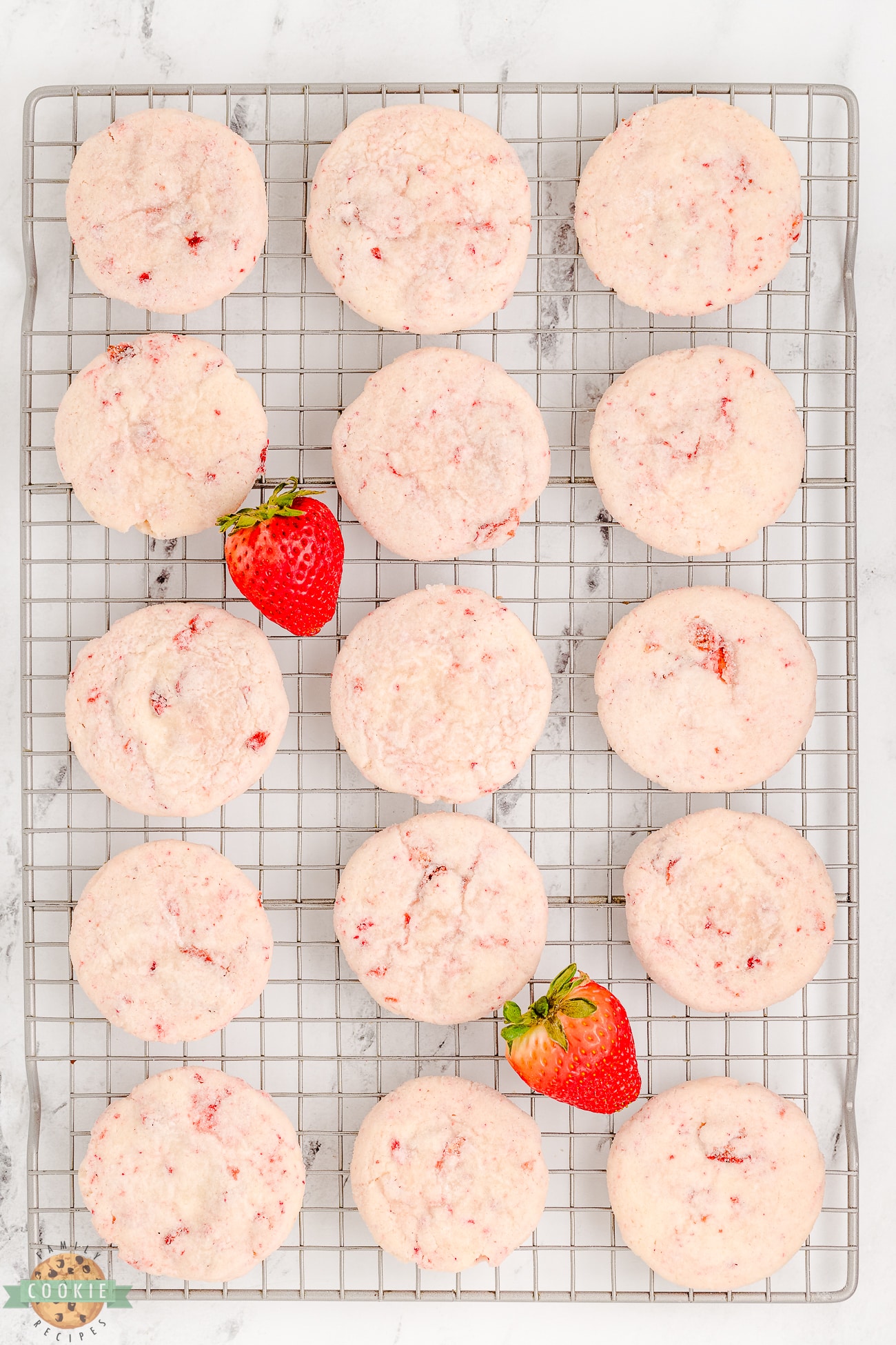 sugar cookies made with strawberry cream cheese on a cooling rack