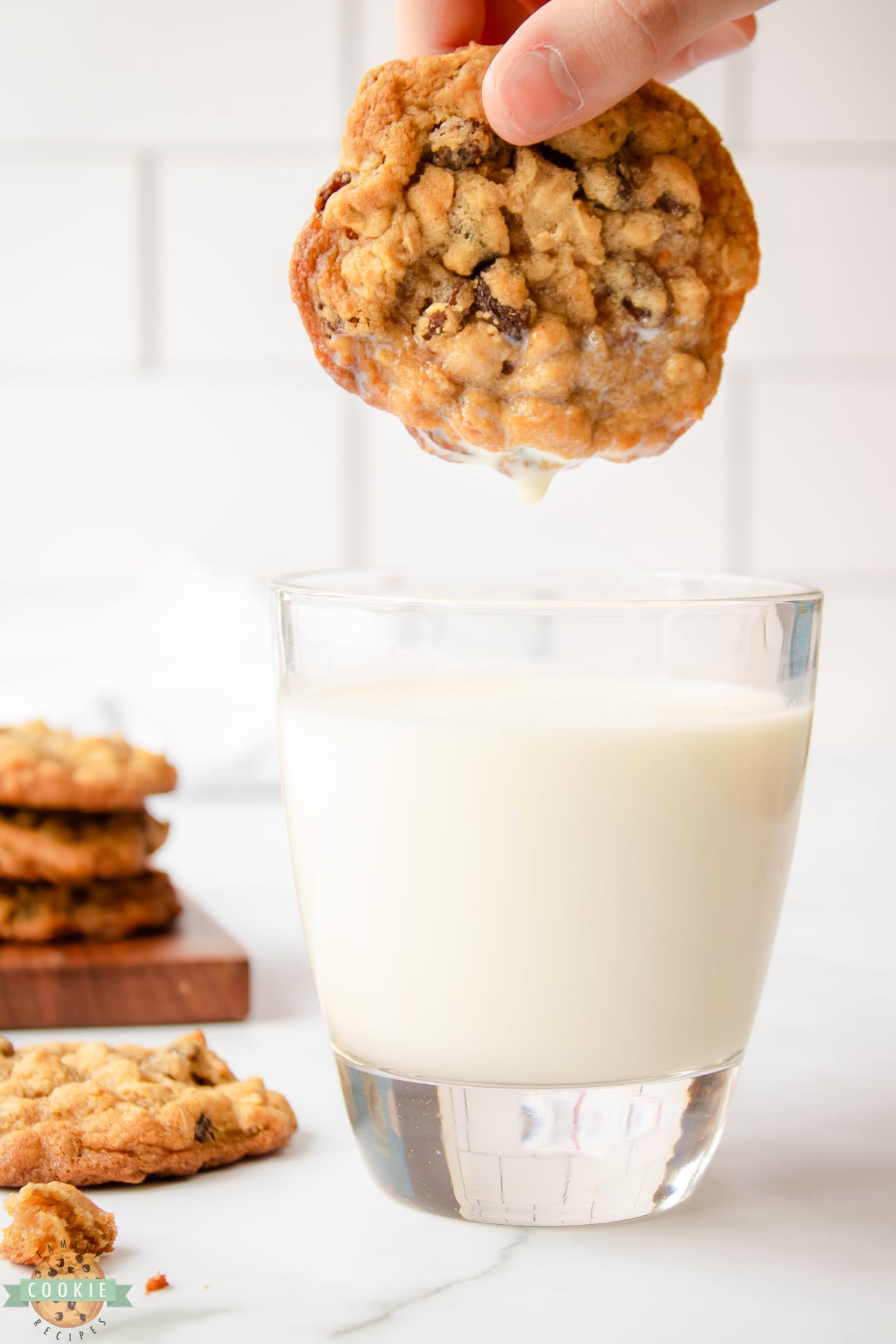 dunking oatmeal raisin cookie in milk
