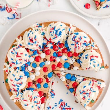 red, white and blue 4th of July cookie cake with slices cut out