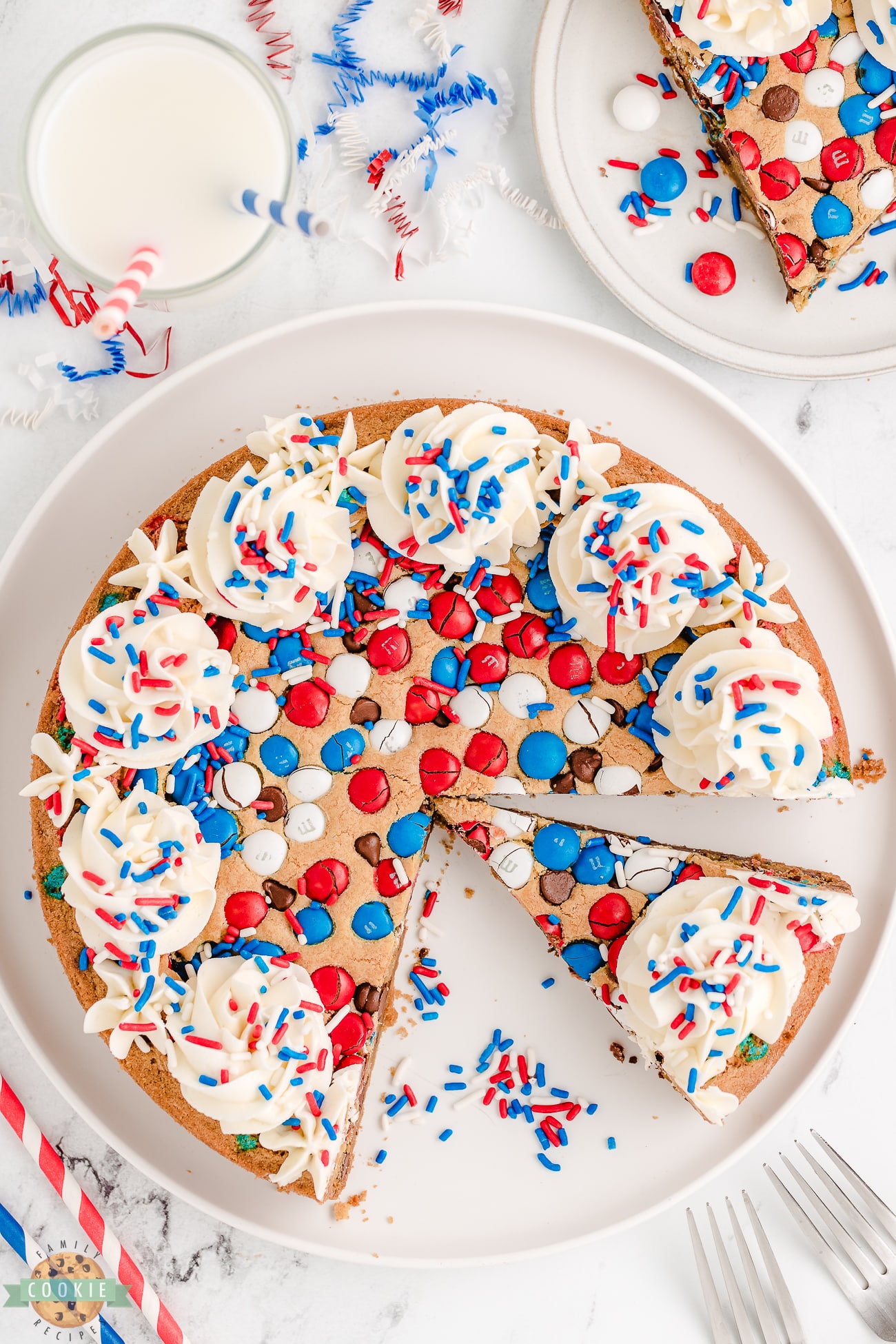 red, white and blue 4th of July cookie cake with slices cut out
