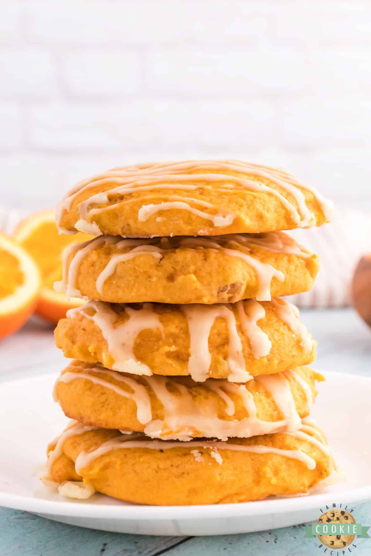 Stack of pumpkin cookies with orange glaze