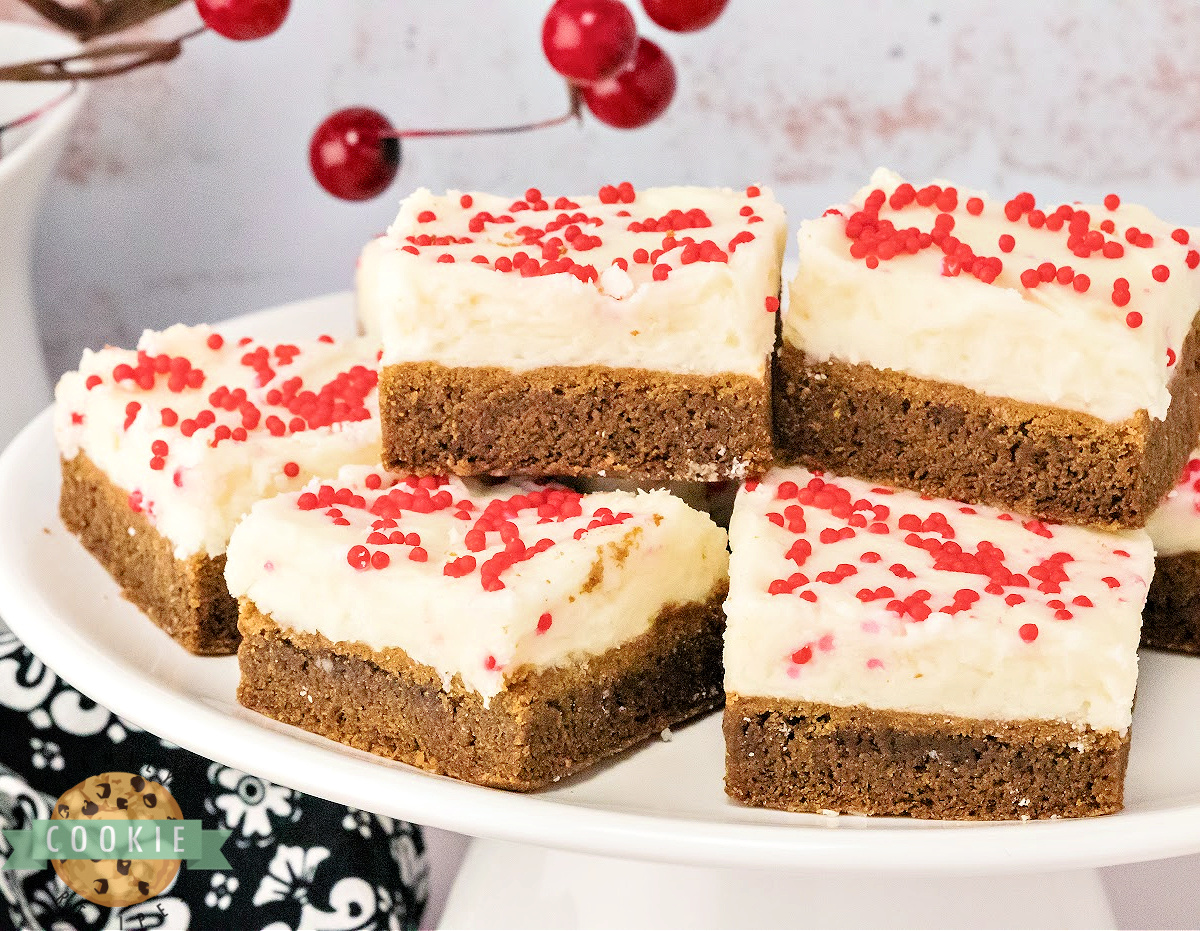 Pan of soft, thick Gingerbread Cookie Bars sliced into squares with a creamy frosting layer.