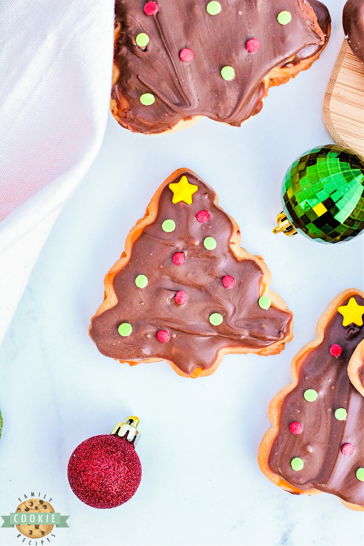Homemade twix cookies in the shape of Christmas trees.