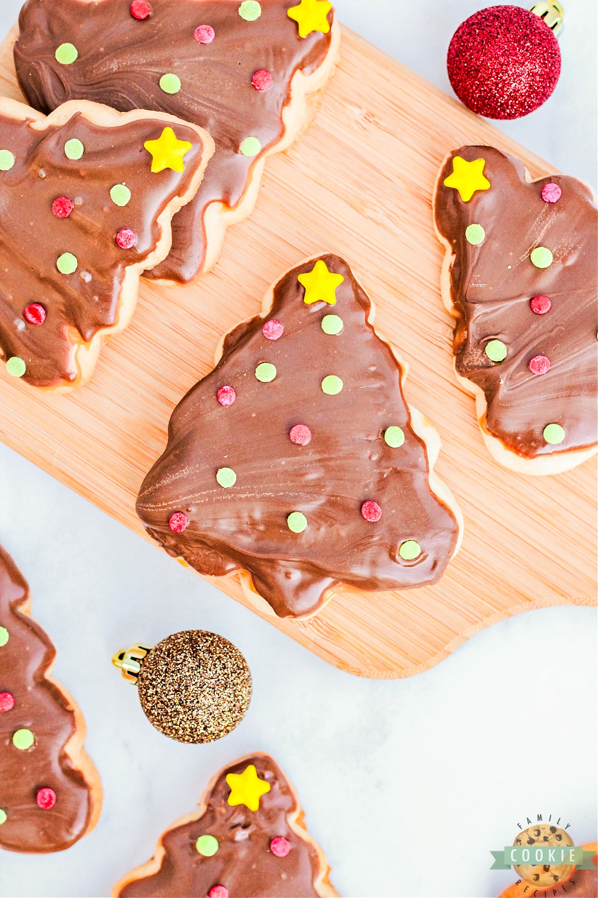 Christmas Tree Twix Cookies are made with a simple sugar cookie topped with caramel, chocolate, and festive sprinkles. Delicious holiday cookies that taste just like your favorite candy bar!