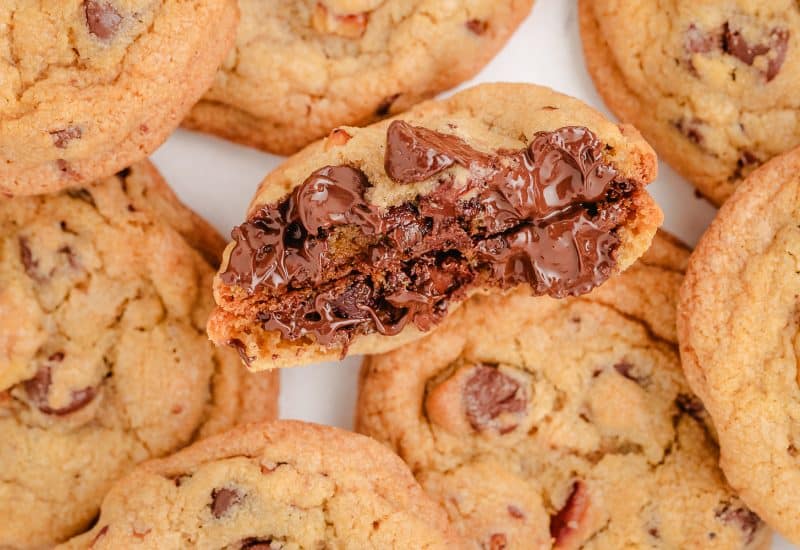 toasted walnut chocolate chip cookie broken in half with melty chocolate