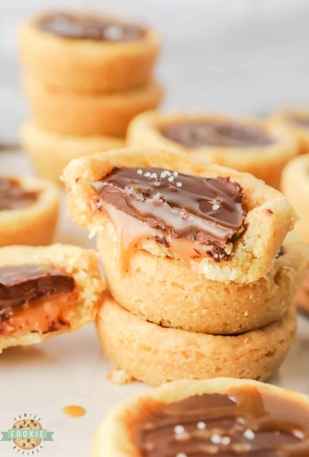 Twix Cookie Cups are so easy to make with pre-made cookie dough, caramels and chocolate chips! Only a few ingredients needed to make these delicious chocolate caramel cookie cups.