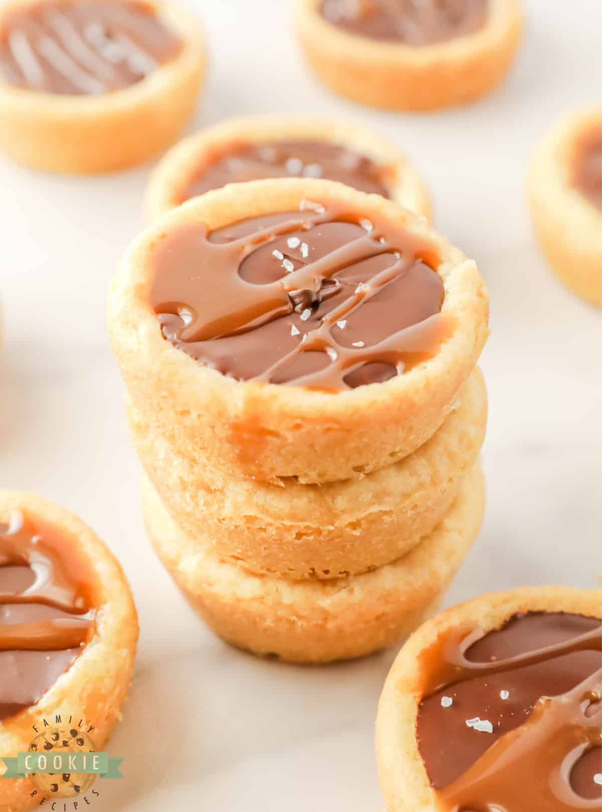 Stack of cookie cups filled with chocolate and caramel. 