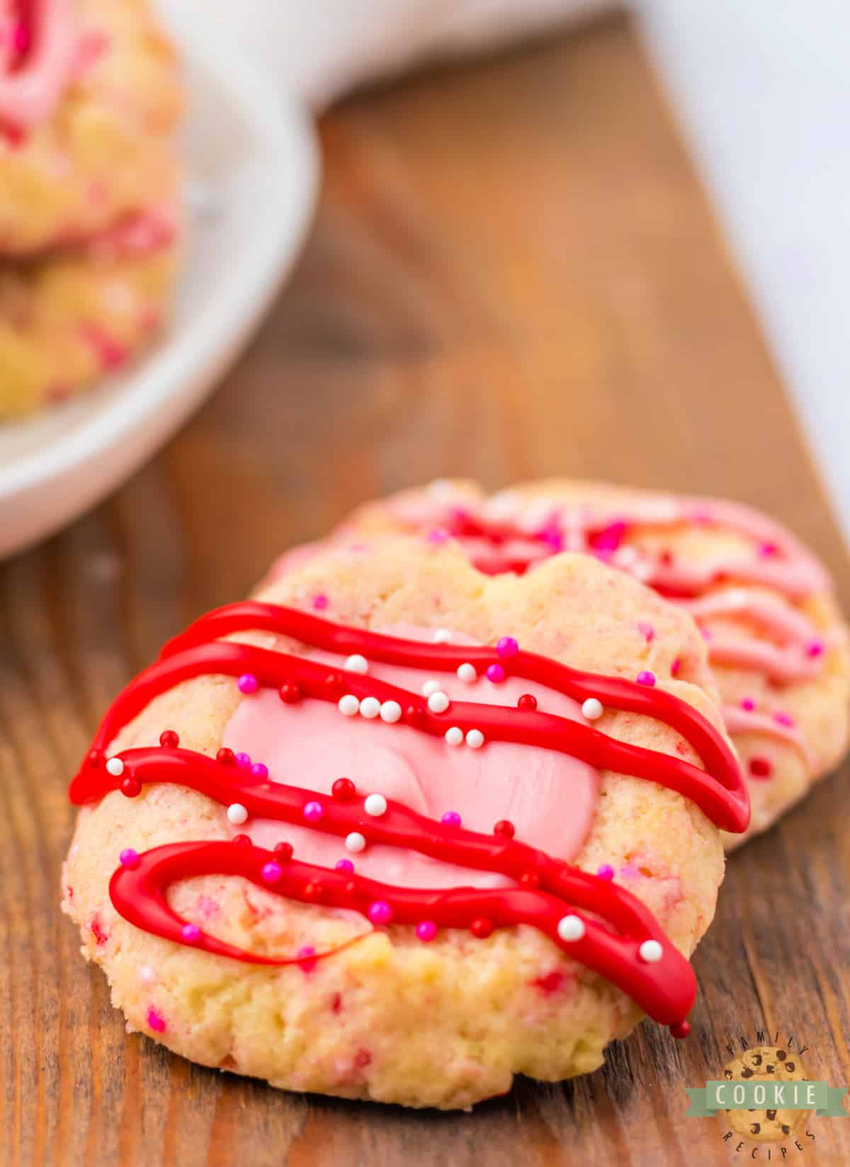 Buttery cookie with pink chocolate filling with a red chocolate drizzle. 