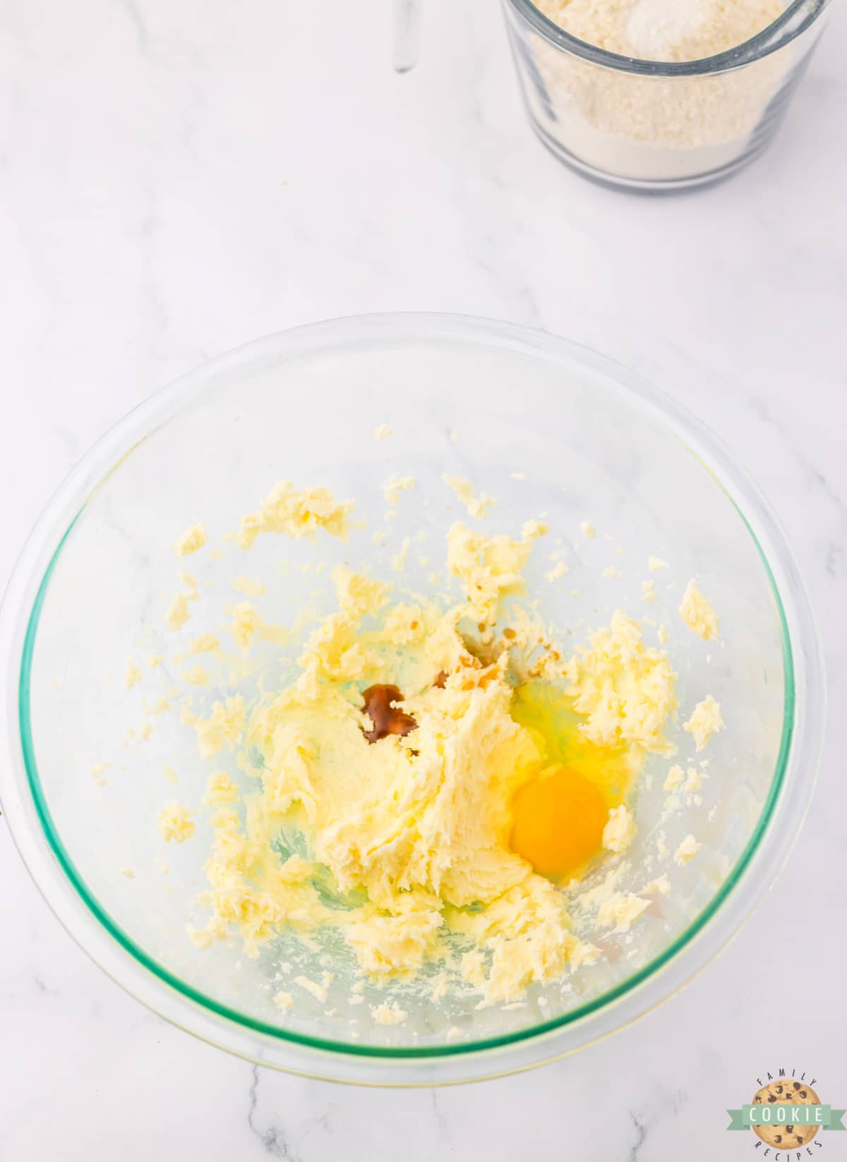 Mixing butter, sugar, egg and vanilla together. 