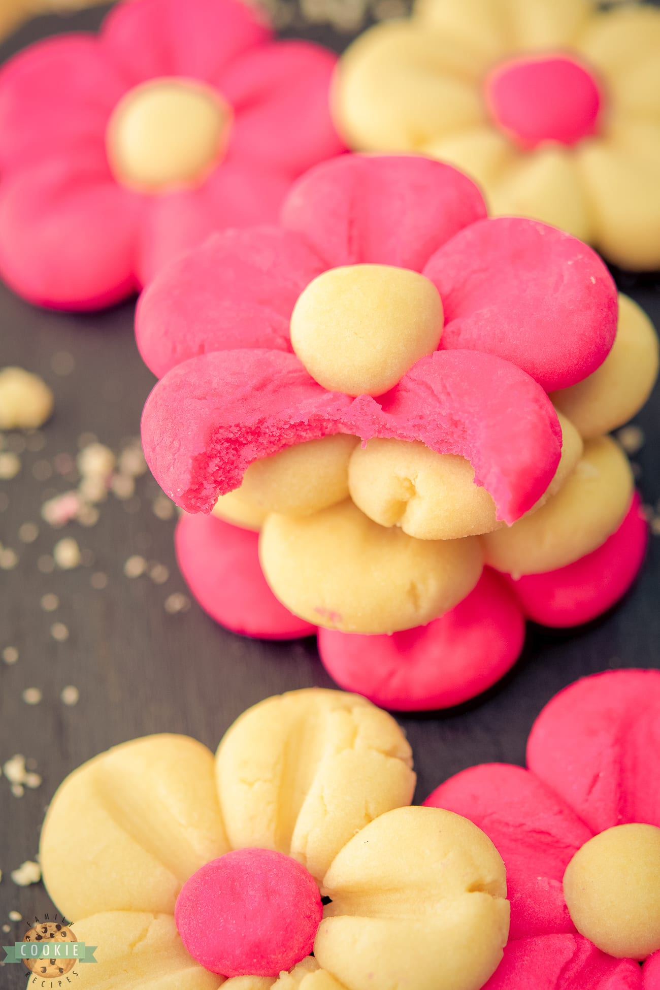 pink daisy cookies with a bite taken out