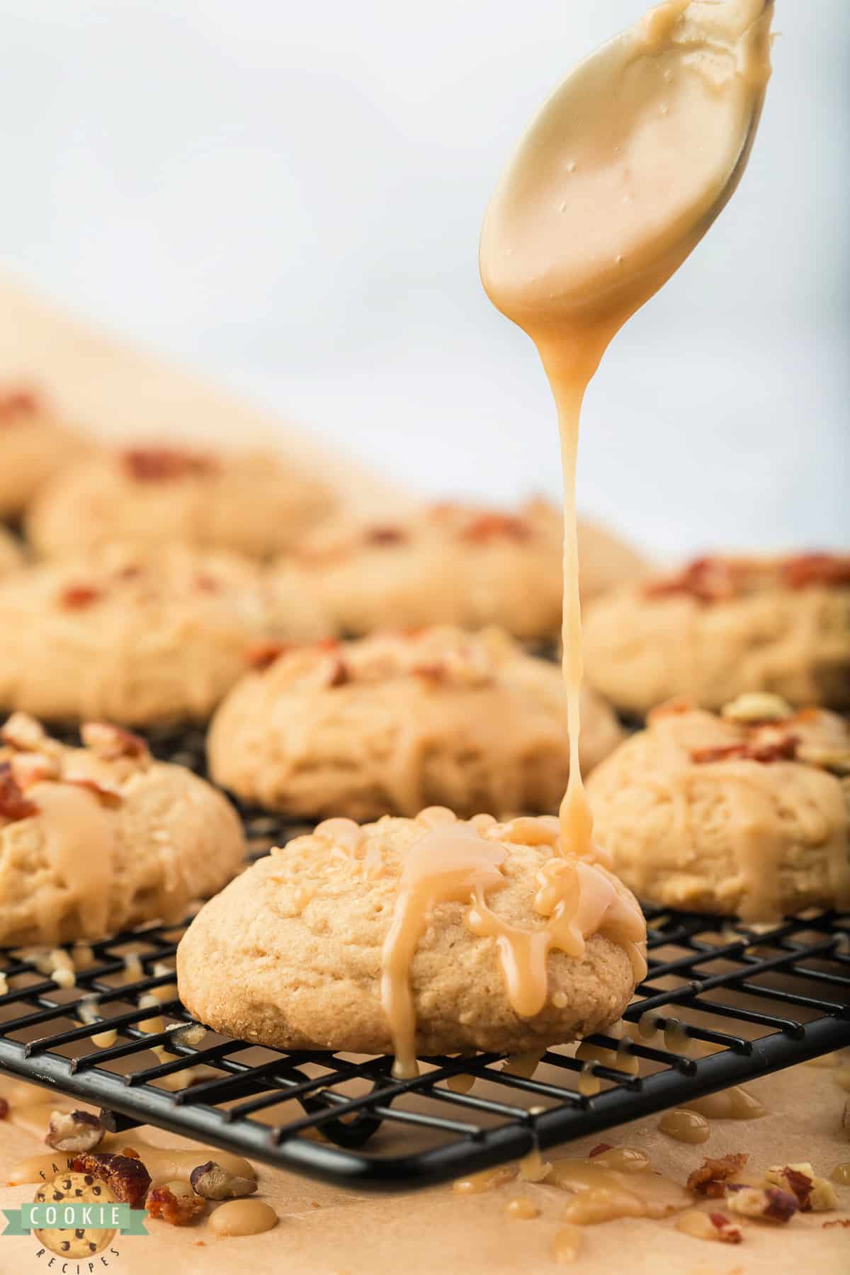 Drizzling maple glaze on top of baked cookies.