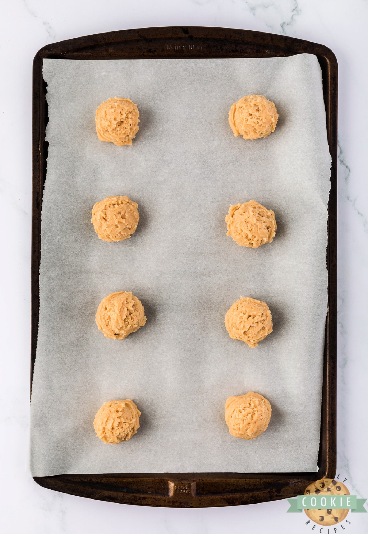 Placing cookie dough on cookie sheet. 