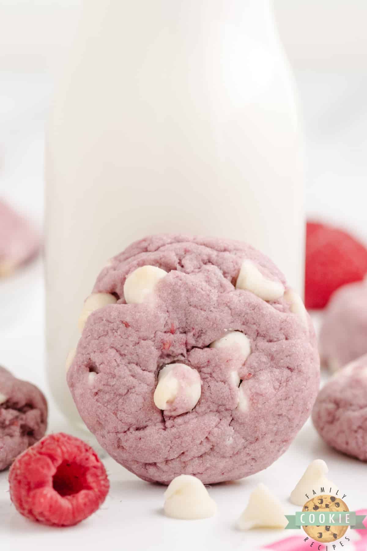 Raspberry White Chocolate Chip cookie with a glass of milk. 