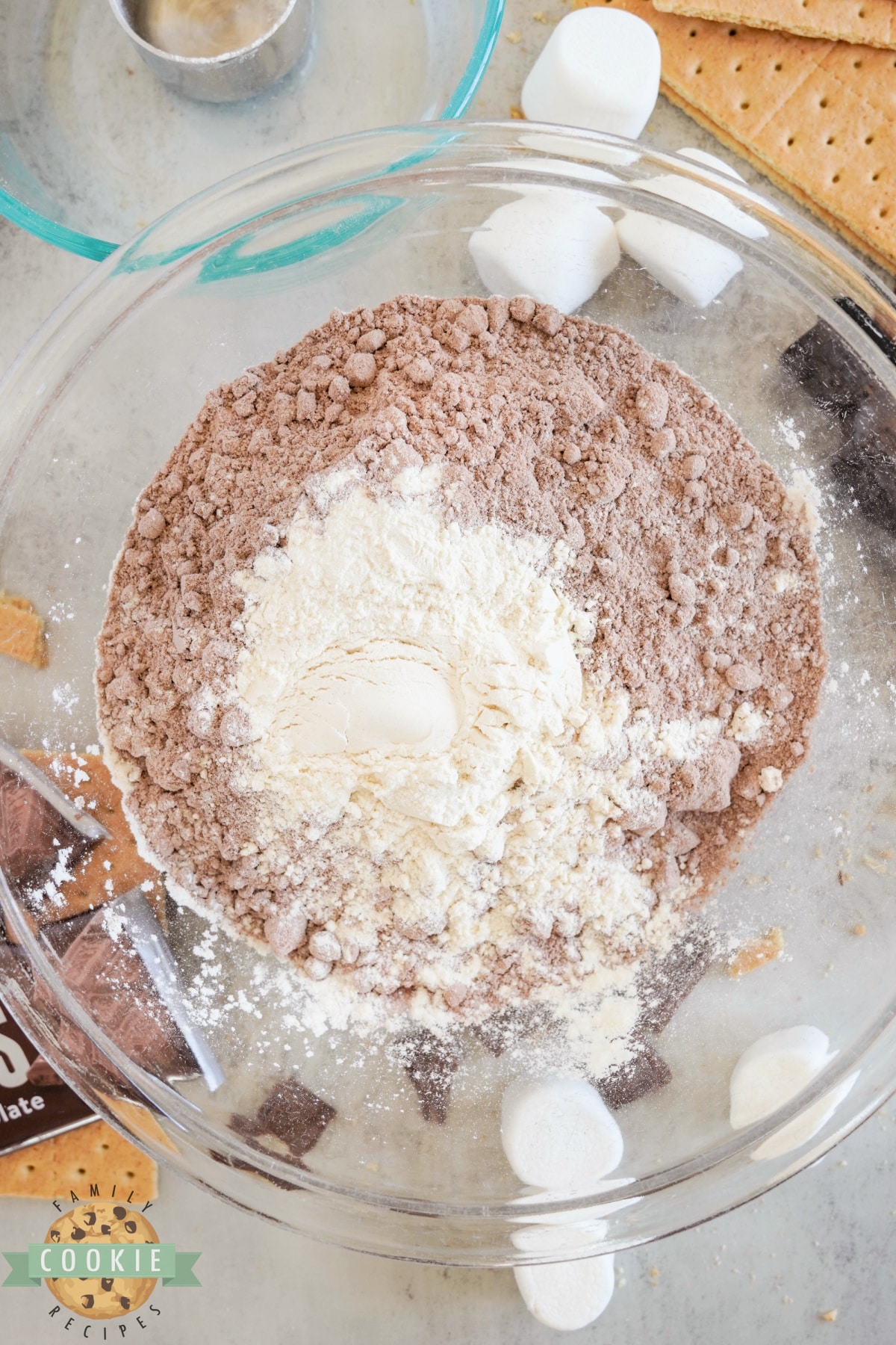 Mixing brownie mix and flour together. 