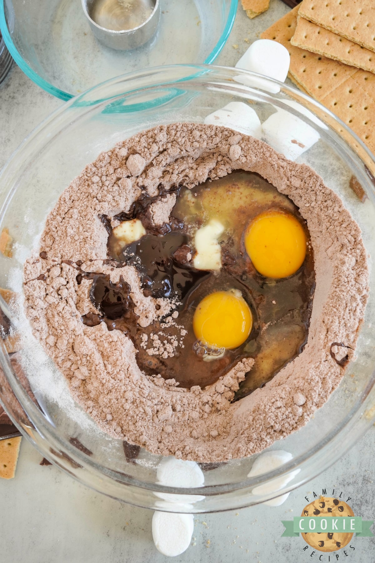 Adding wet ingredients to cookie dough. 