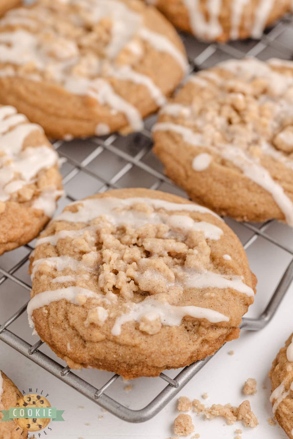 Cinnamon cookie topped with crumb topping and vanilla glaze. 