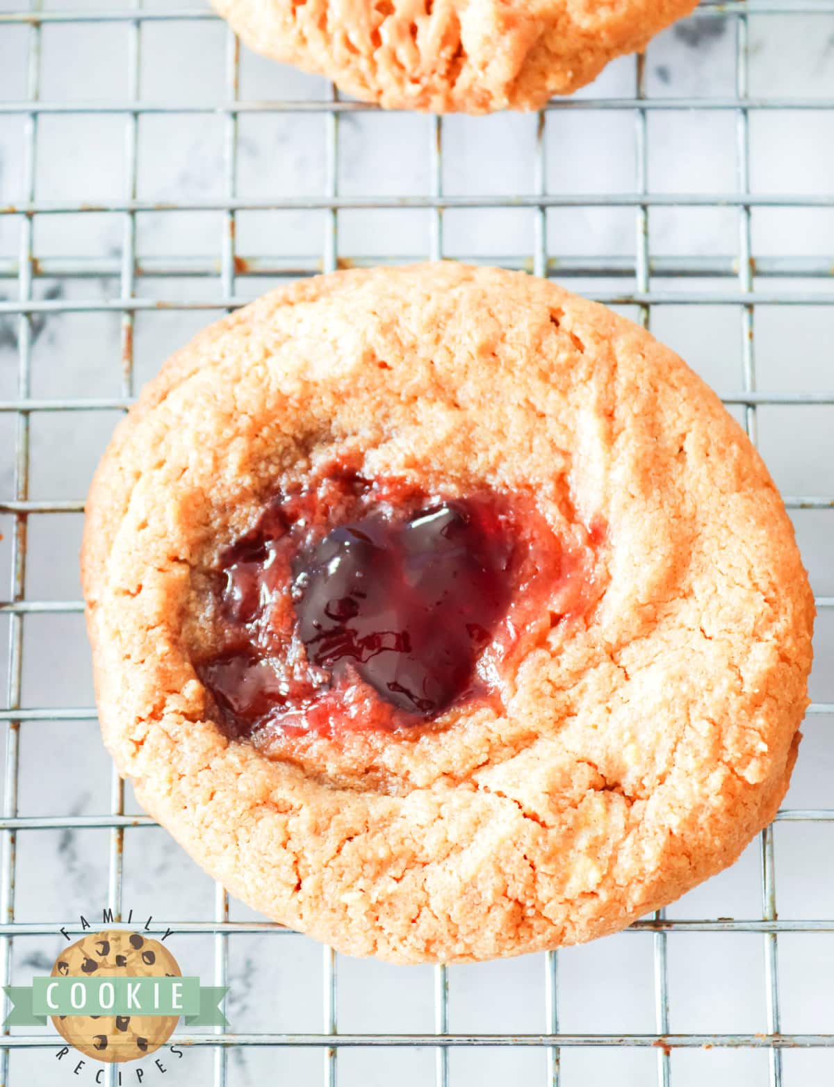 Peanut Butter and Jelly Cookies are made with just 4 ingredients! Simple thumbprint cookies made with peanut butter, sugar, and eggs before being filled with jelly.  