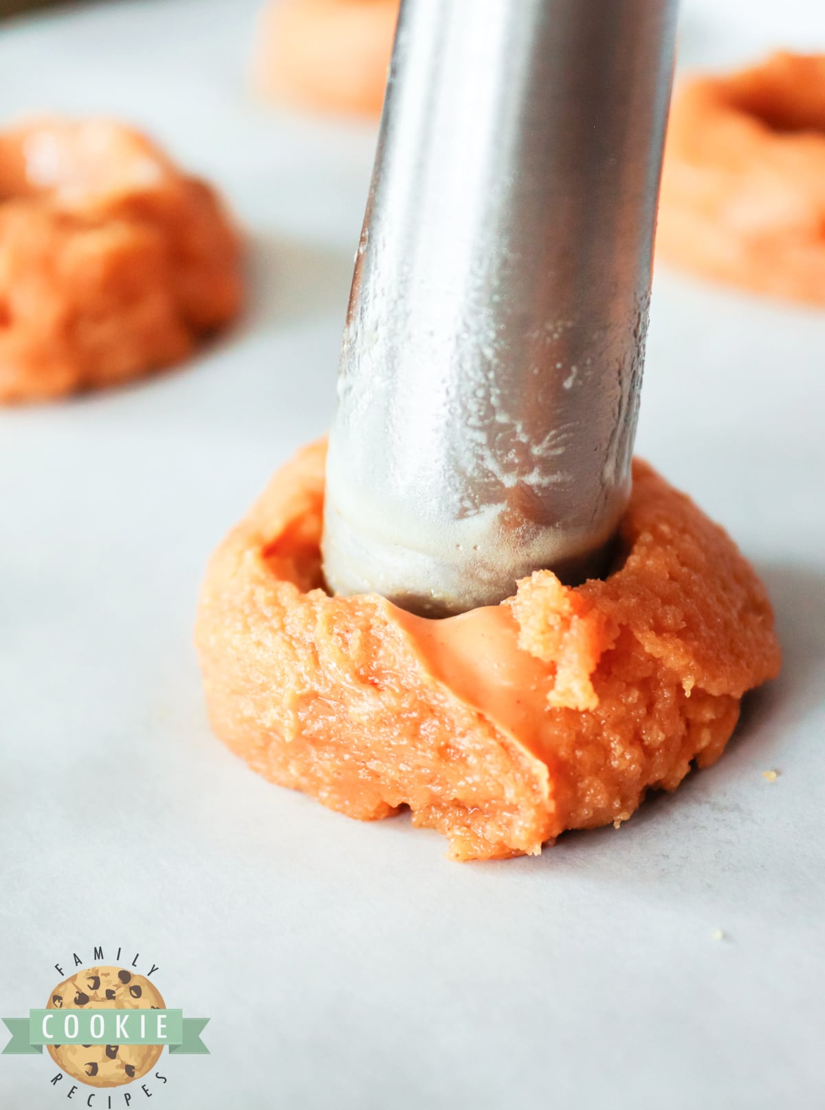 Making indentation in peanut butter cookies. 