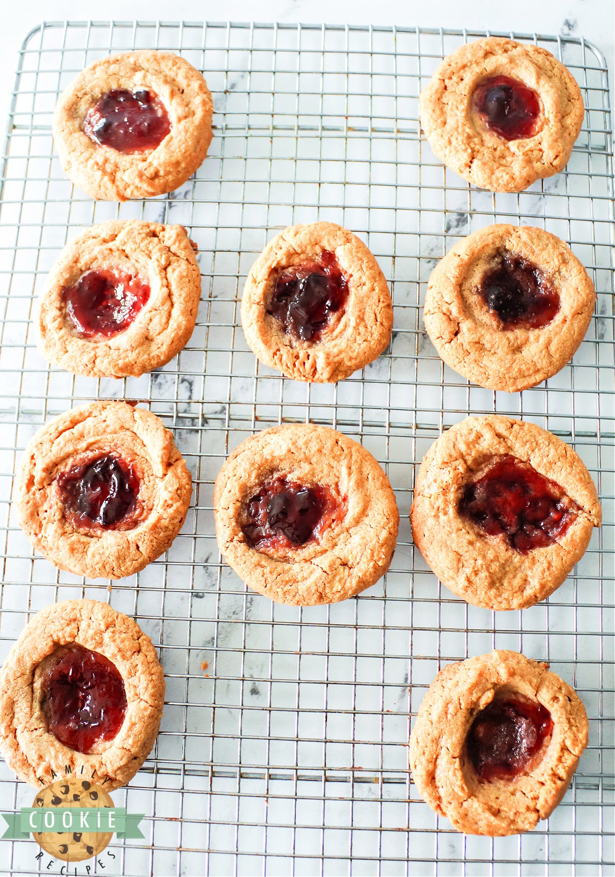 Peanut Butter and Jelly Cookies are made with just 4 ingredients! Simple thumbprint cookies made with peanut butter, sugar, and eggs before being filled with jelly.  