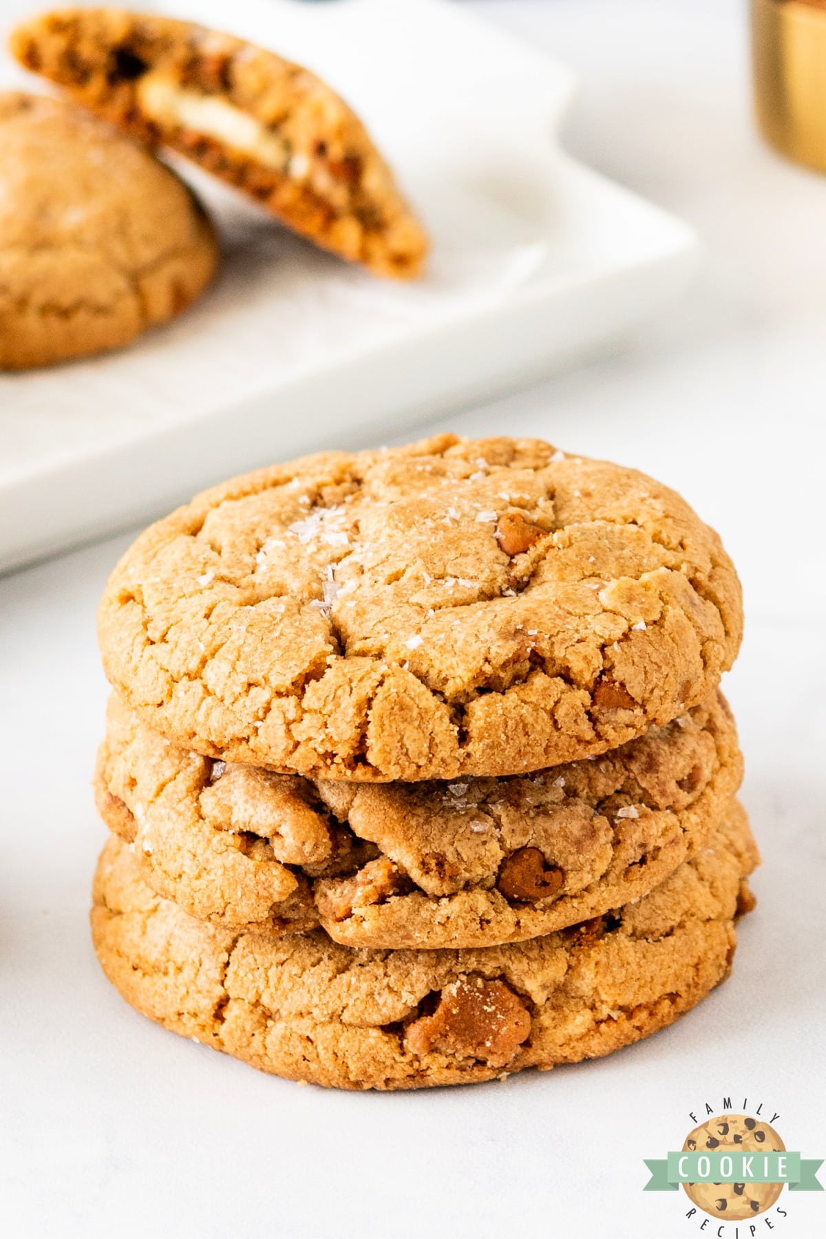 Stack of biscoff cookies with a little bit of salt on top. 