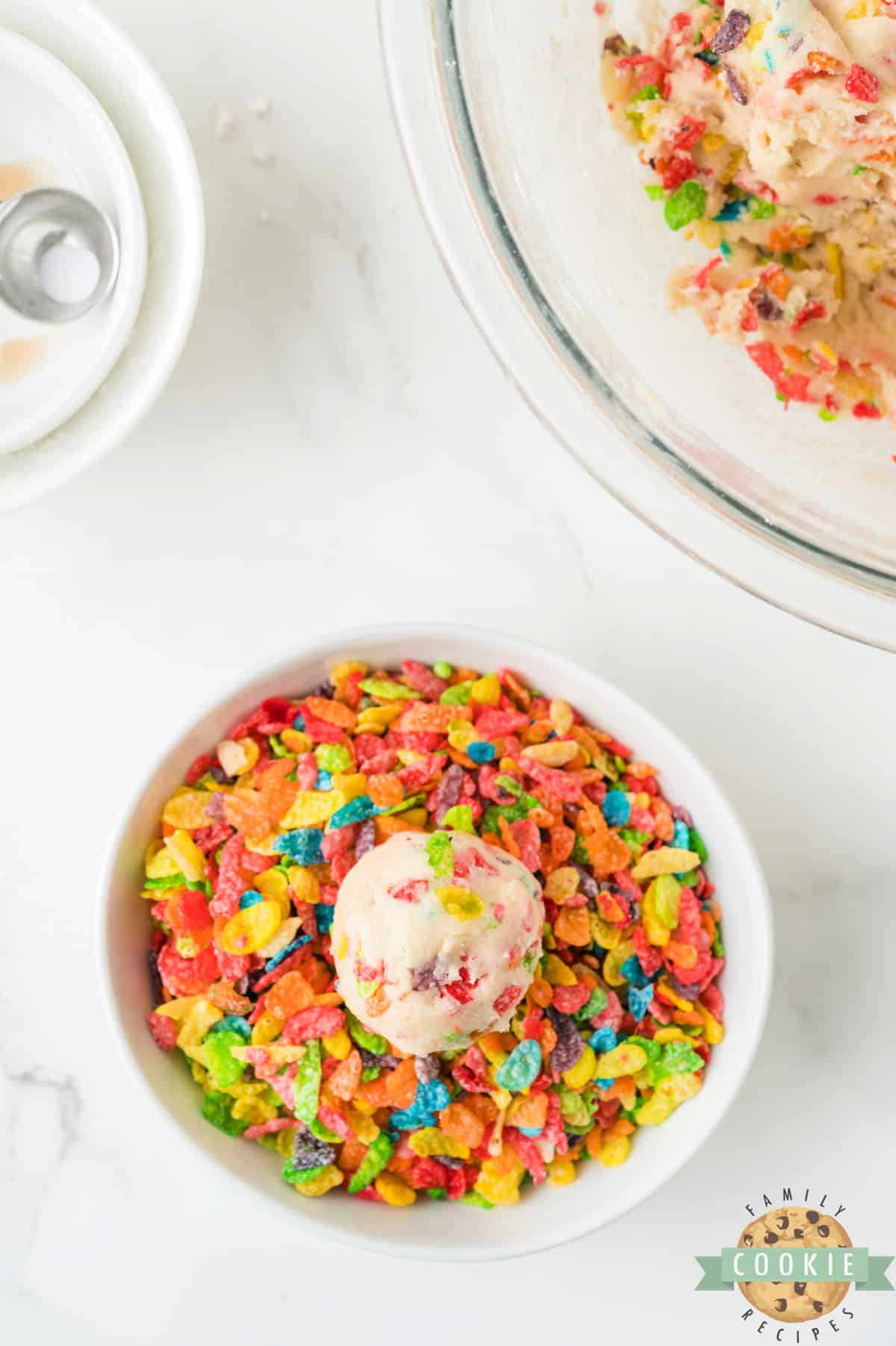 Roll cookie dough ball in cereal. 