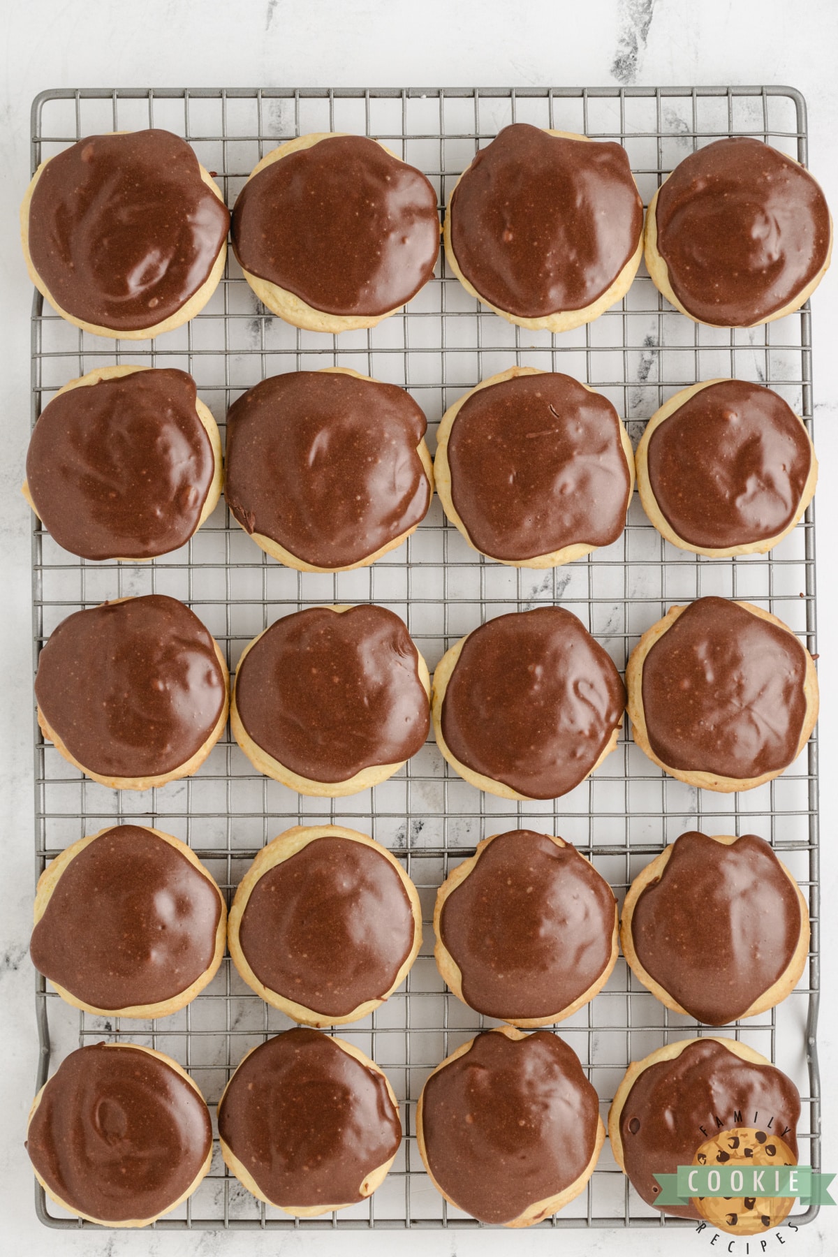 Fudge topping on orange cookies.