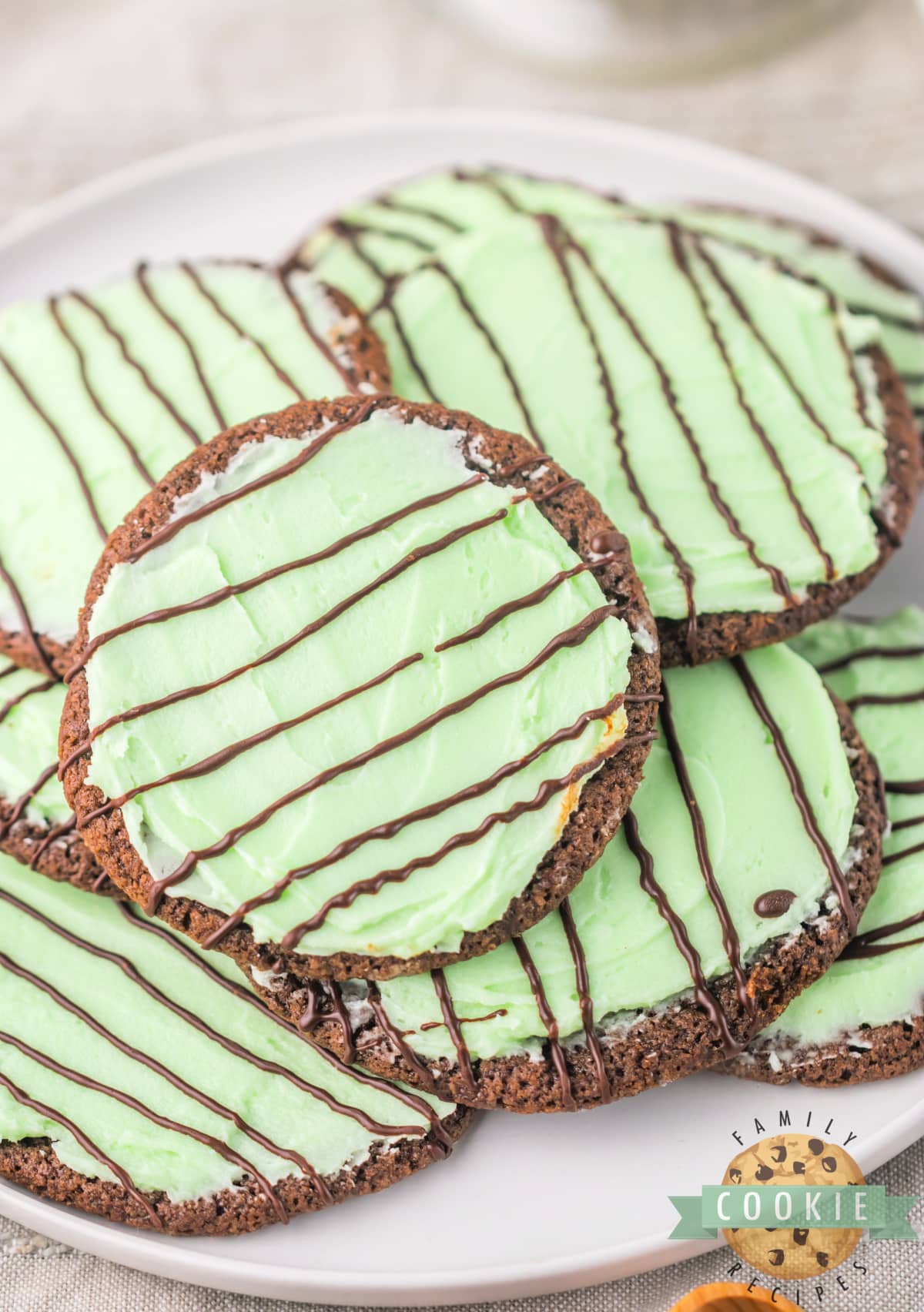 Frosted Mint Chocolate Cookies are soft cookies topped with mint frosting that taste very similar to the Girl Scout Thin Mint cookies that we all know and love. An easy cookie recipe that is great for St. Patrick's Day, Christmas, or pretty much any time during the year!