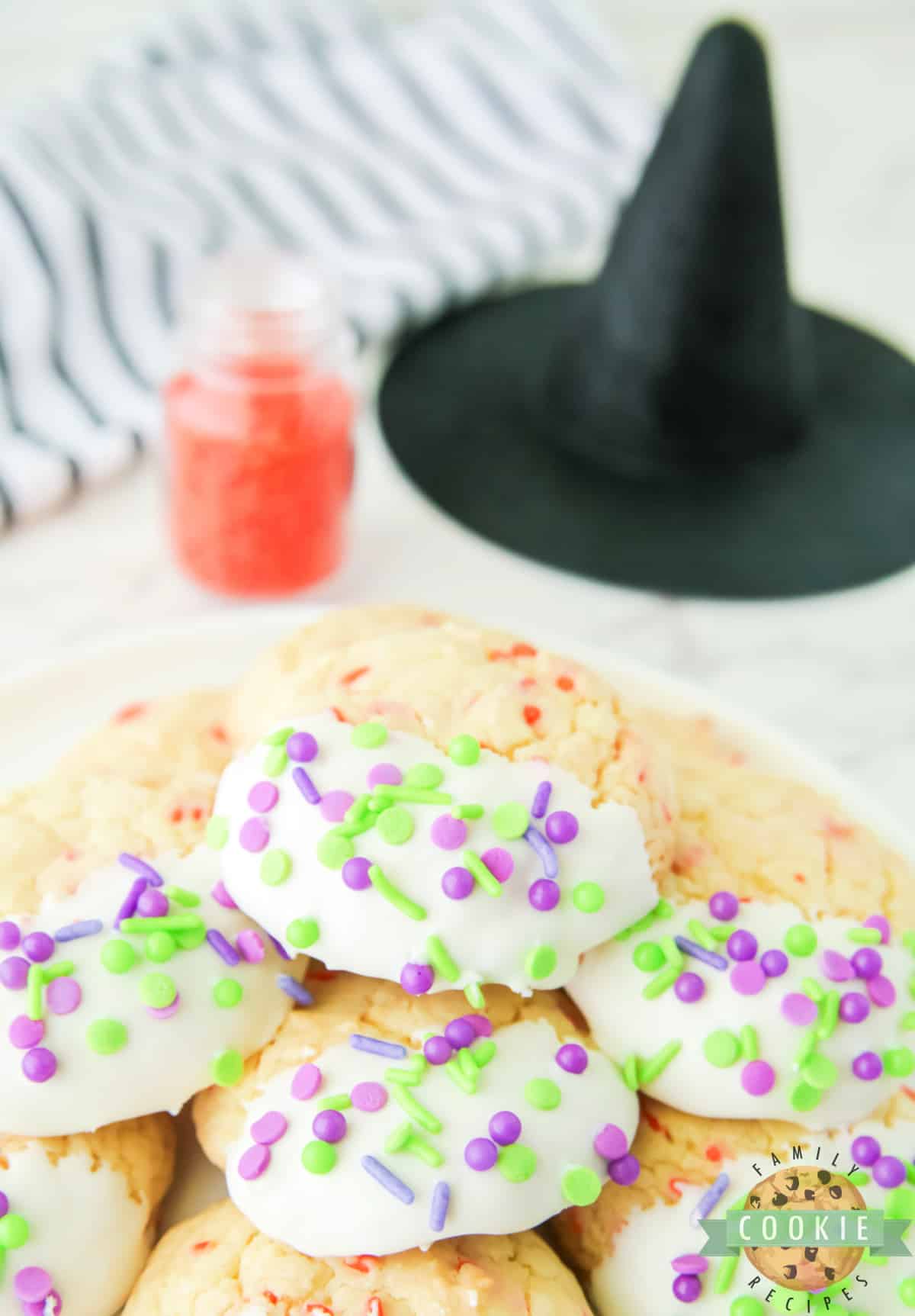 Halloween Cake Mix Sprinkle Cookies are easy to make and perfectly festive for Halloween. Use a cake mix, vanilla frosting, and colorful sprinkles to make these simple holiday cookies.