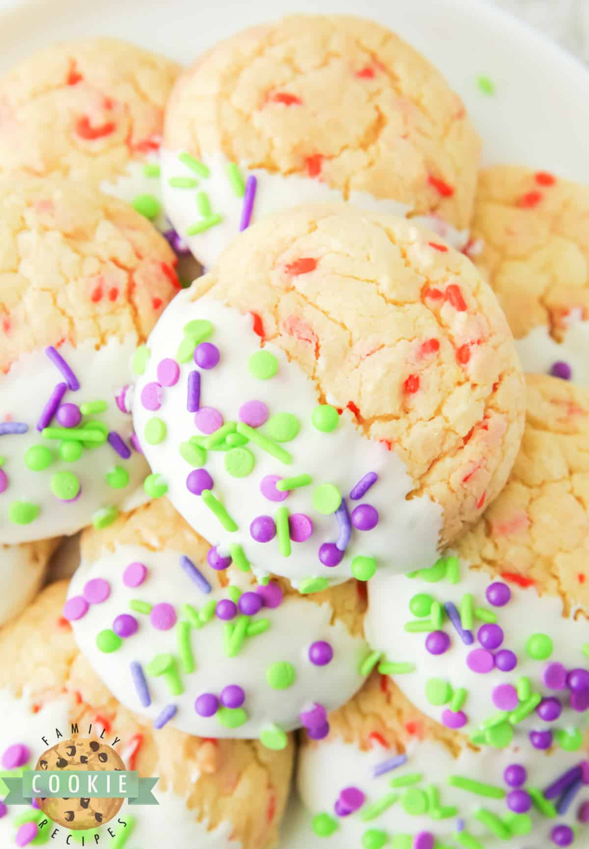 Halloween Cake Mix Sprinkle Cookies are easy to make and perfectly festive for Halloween. Use a cake mix, vanilla frosting, and colorful sprinkles to make these simple holiday cookies.