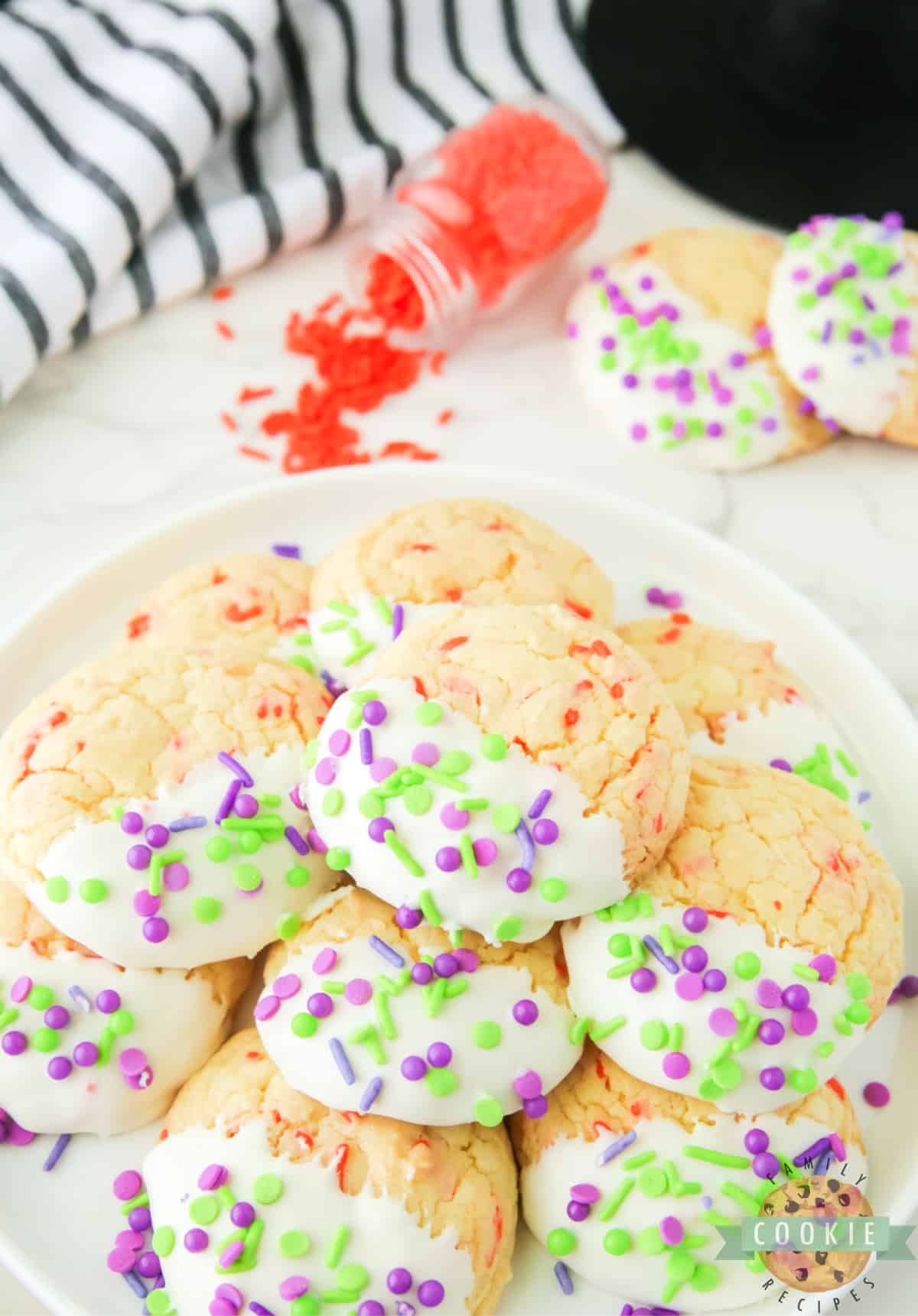 Halloween Cake Mix Sprinkle Cookies are easy to make and perfectly festive for Halloween. Use a cake mix, vanilla frosting, and colorful sprinkles to make these simple holiday cookies.