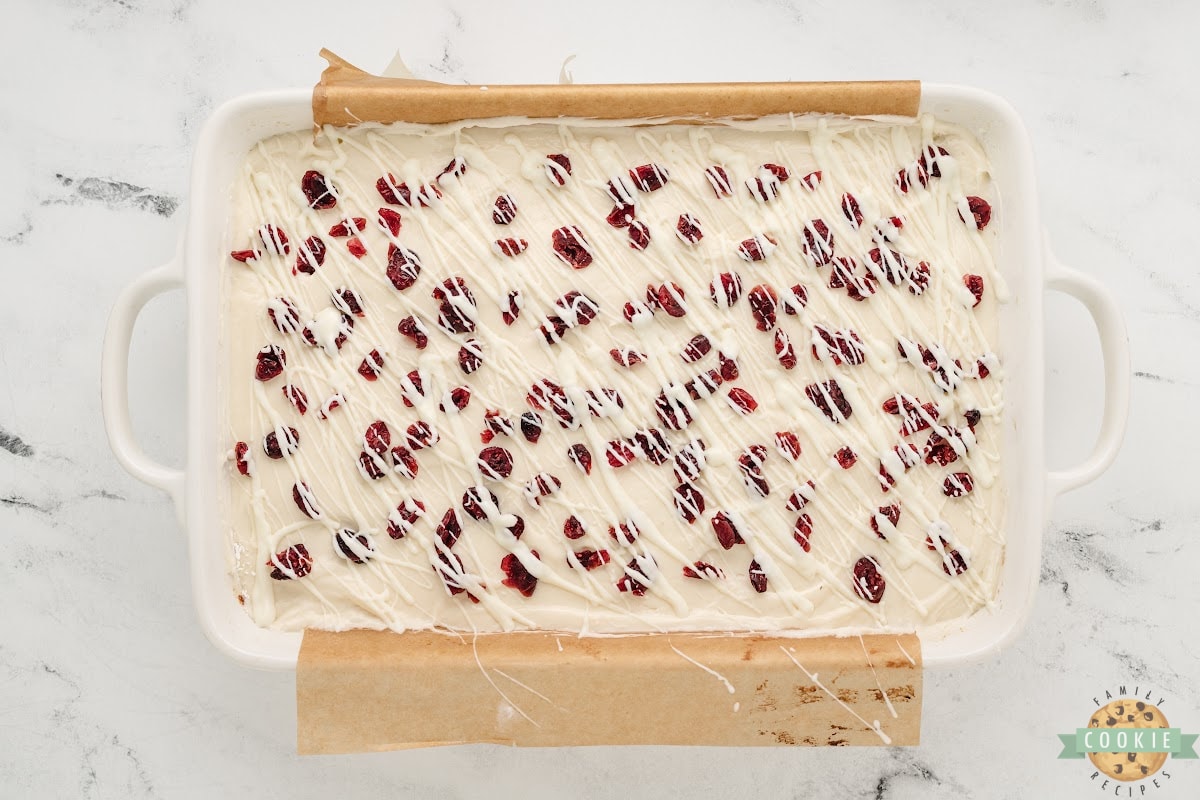 Add white chocolate drizzle on top of frosted cookie bars. 