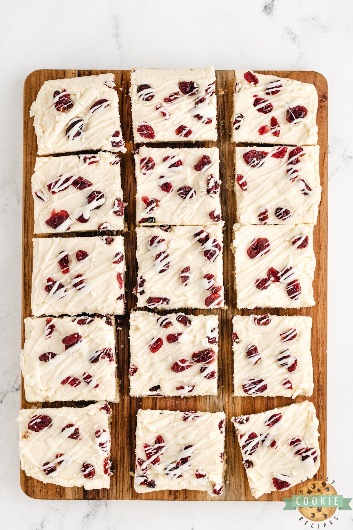 Cookie bars made with cream cheese frosting and dried cranberries.