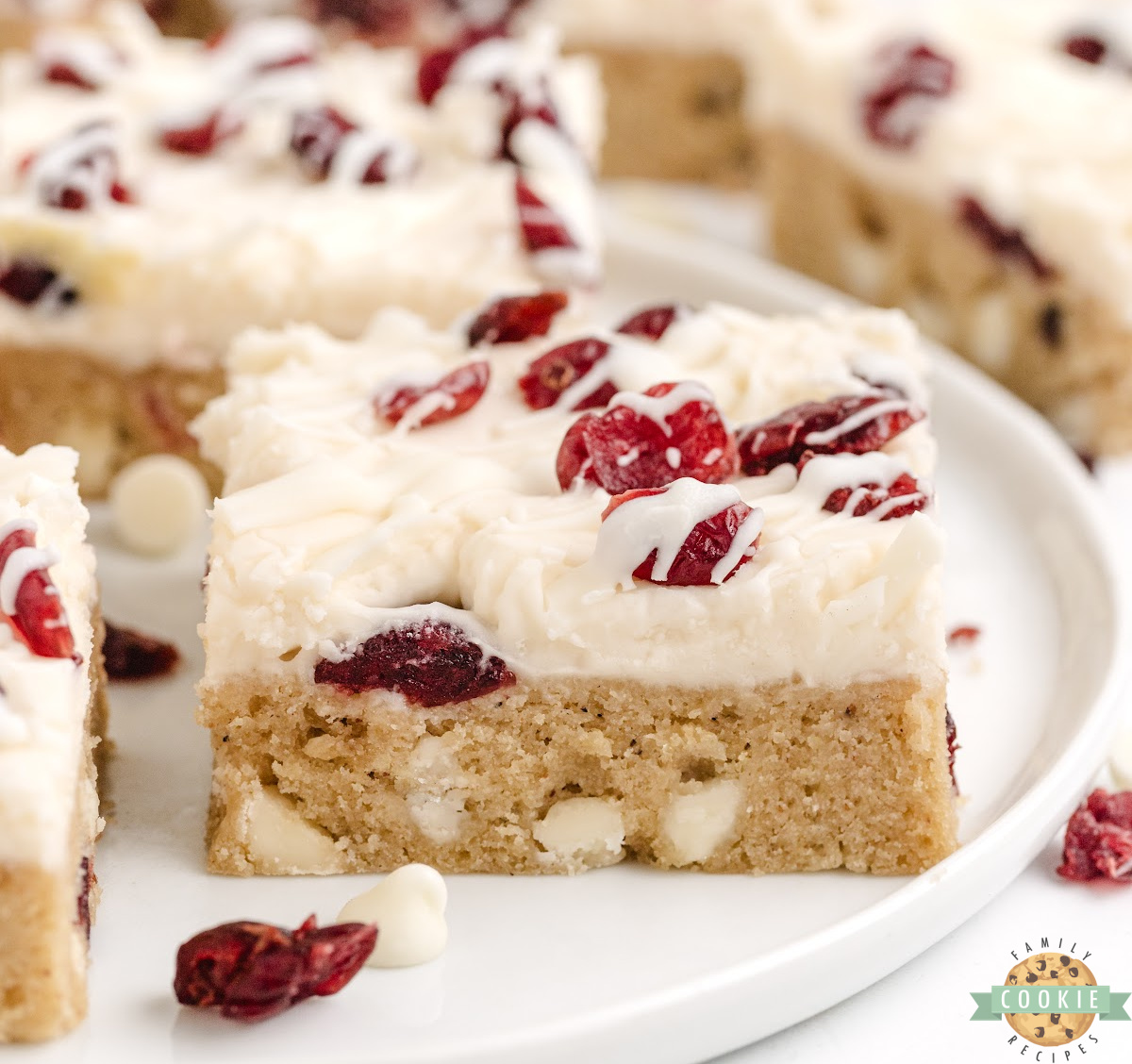 White Chocolate Cranberry Cookie Bars are soft, chewy, and covered with cream cheese frosting and a white chocolate drizzle.