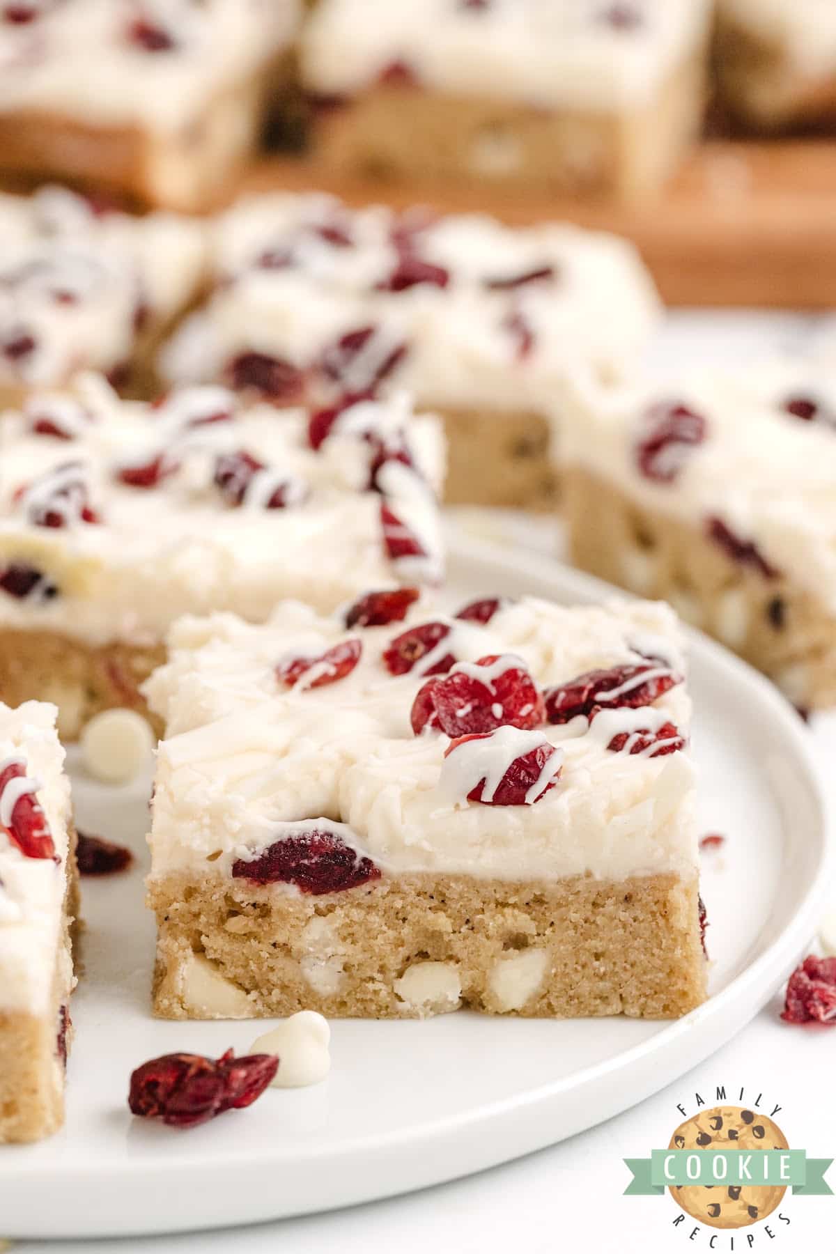 Thick and chewy cookie bar recipe with cream cheese frosting and white chocolate drizzle. 