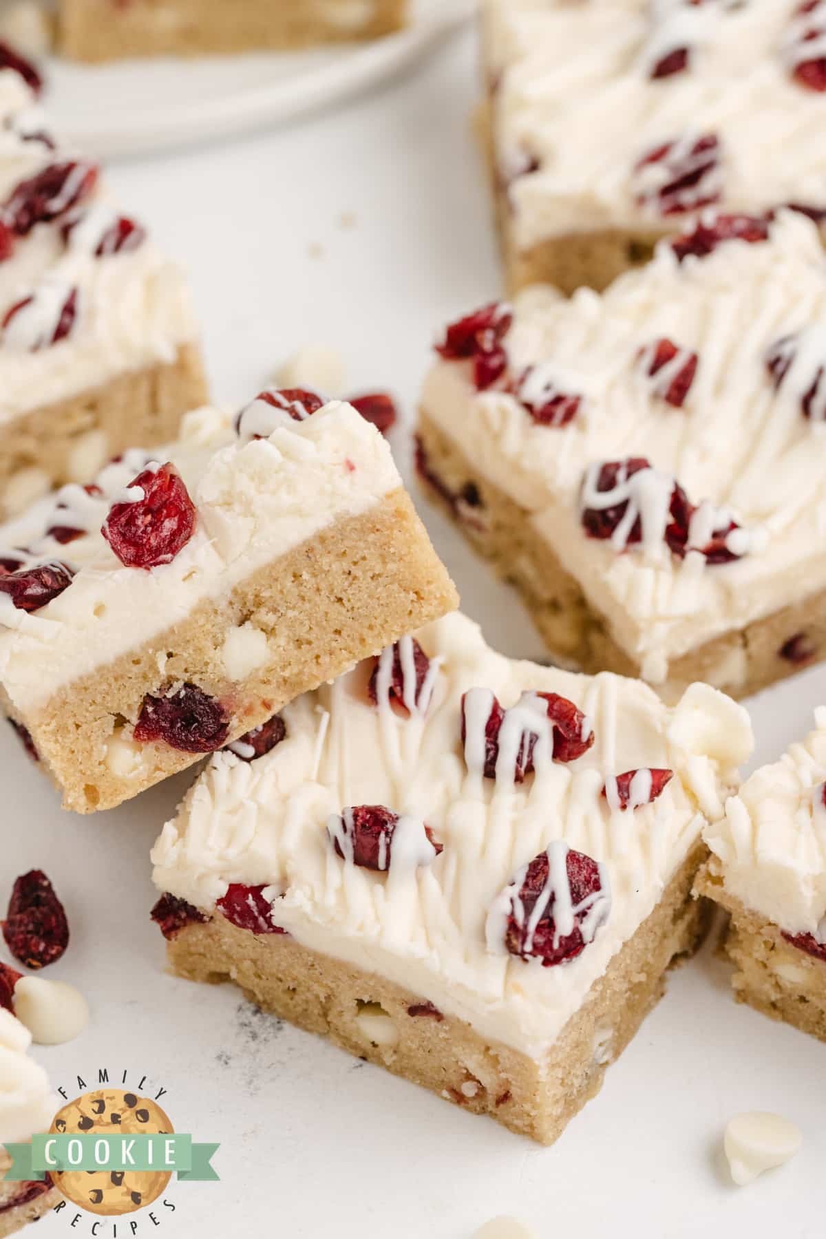 White Chocolate Cranberry Cookie Bars are soft, chewy, and covered with cream cheese frosting and a white chocolate drizzle. This is a fantastic cookie bar recipe that is perfect for fall!