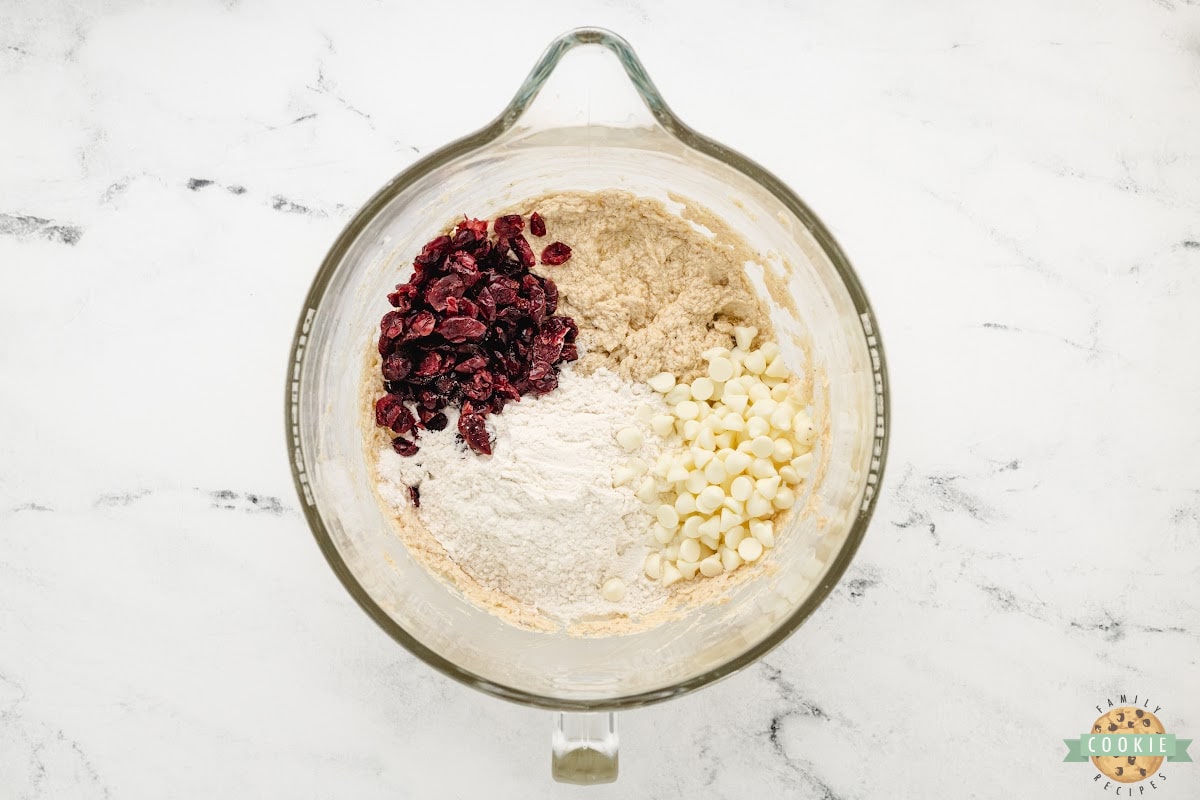 Add flour, white chocolate chips, and dried cranberries. 