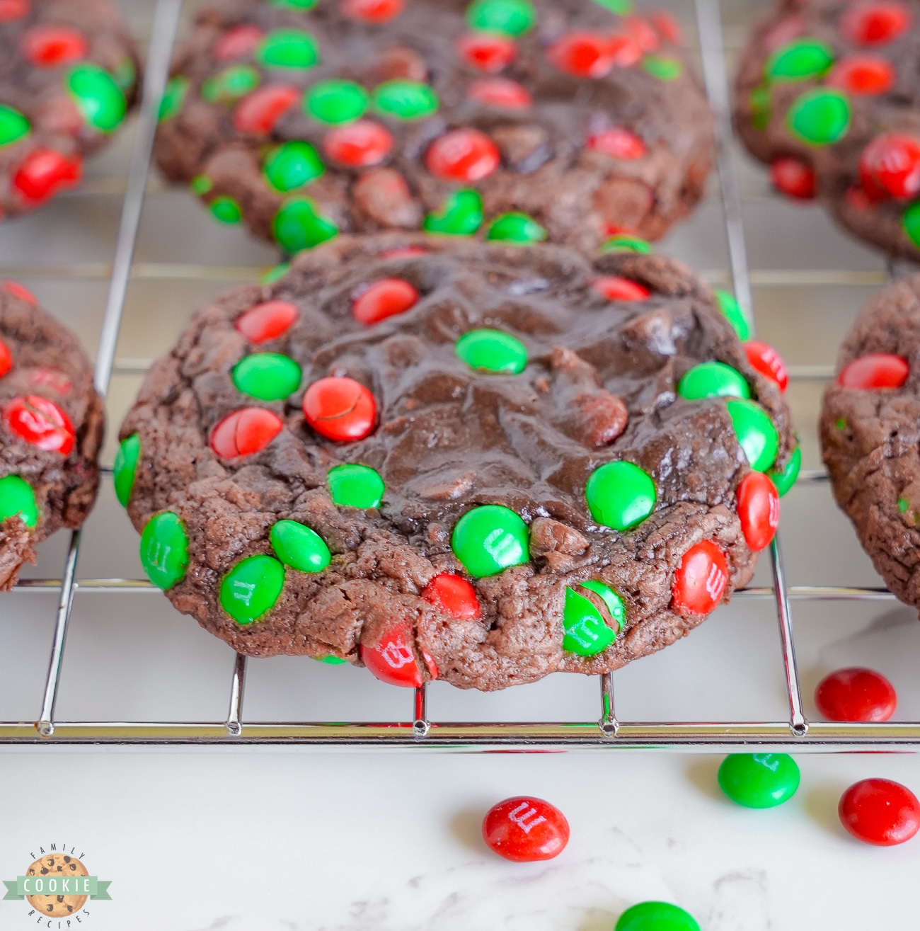 brownie cookies topped with Christmas M&M's on a cooling rack