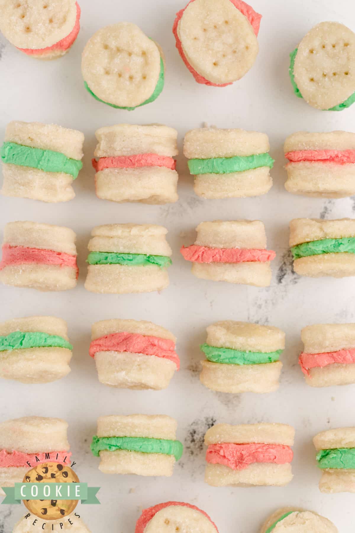 Mini Christmas Sandwich Cookies are the perfect holiday treat! These tiny shortbread cookies with a simple buttercream frosting sandwiched in between are easy to make and fun to eat.