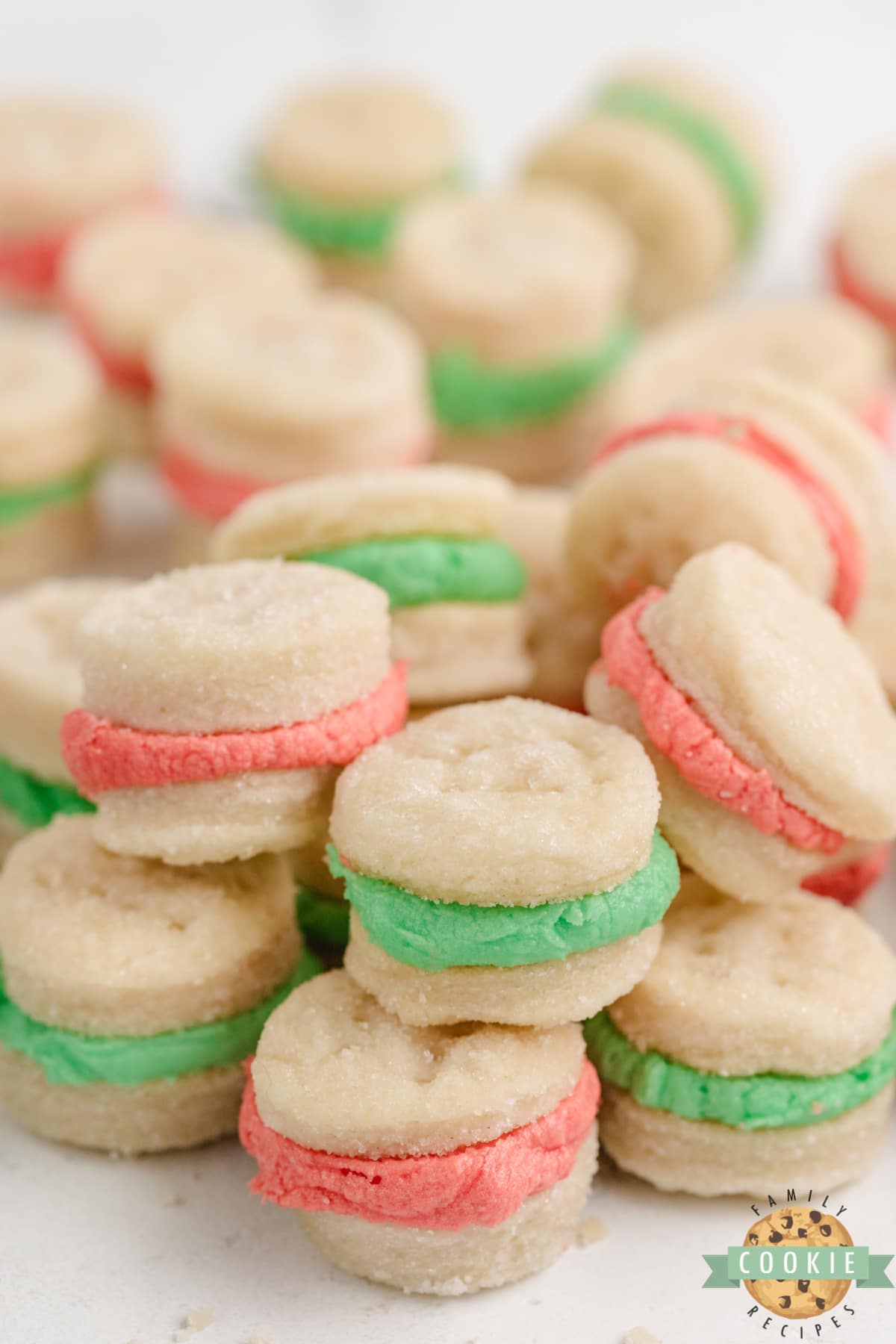 Mini Christmas Sandwich Cookies are the perfect holiday treat! These tiny shortbread cookies with a simple buttercream frosting sandwiched in between are easy to make and fun to eat.