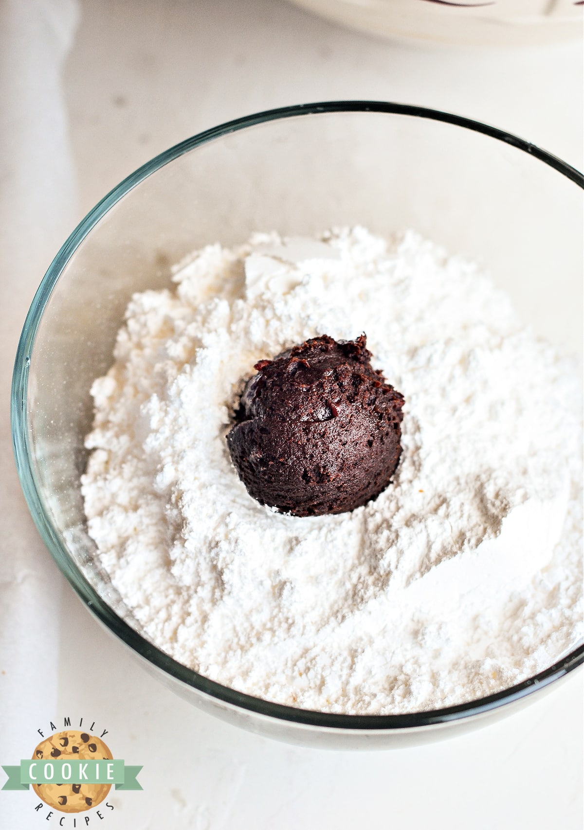 Roll each ball of dough in powdered sugar. 