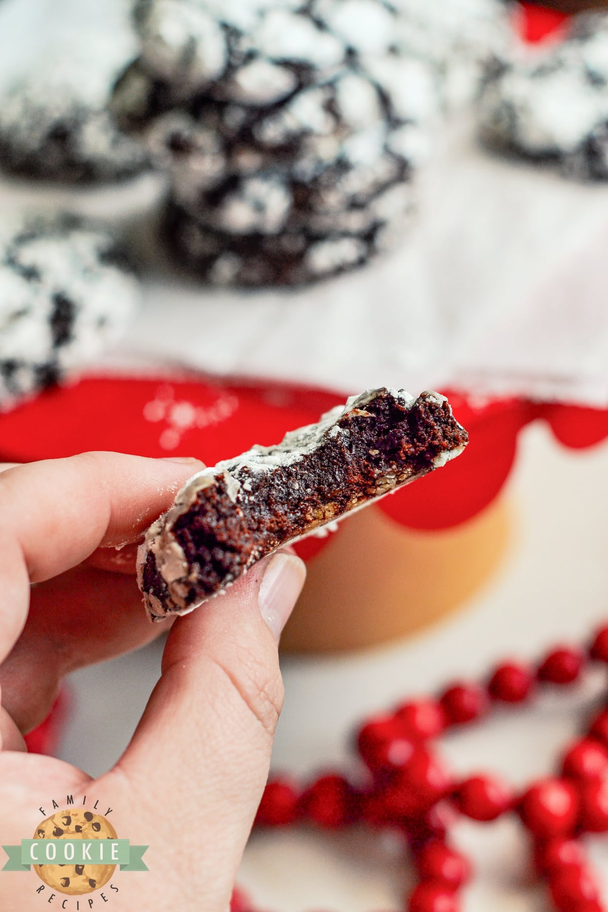 Half of a chocolate crinkle cookie with raspberry jam. 