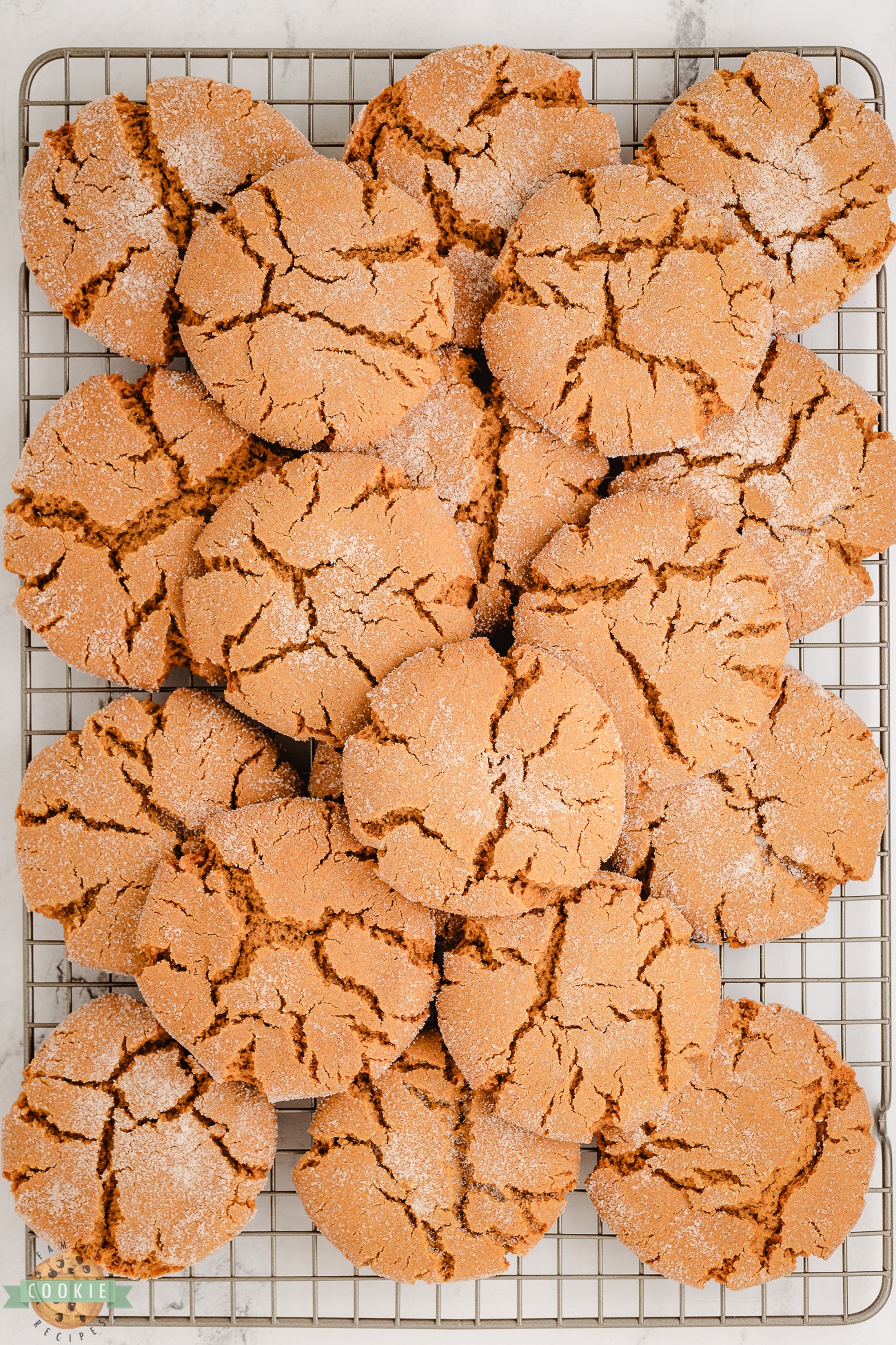 a pile of molasses crackle cookies on a cooling rack