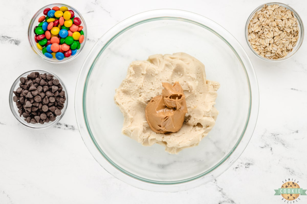 Mixing peanut butter with sugar cookie dough.