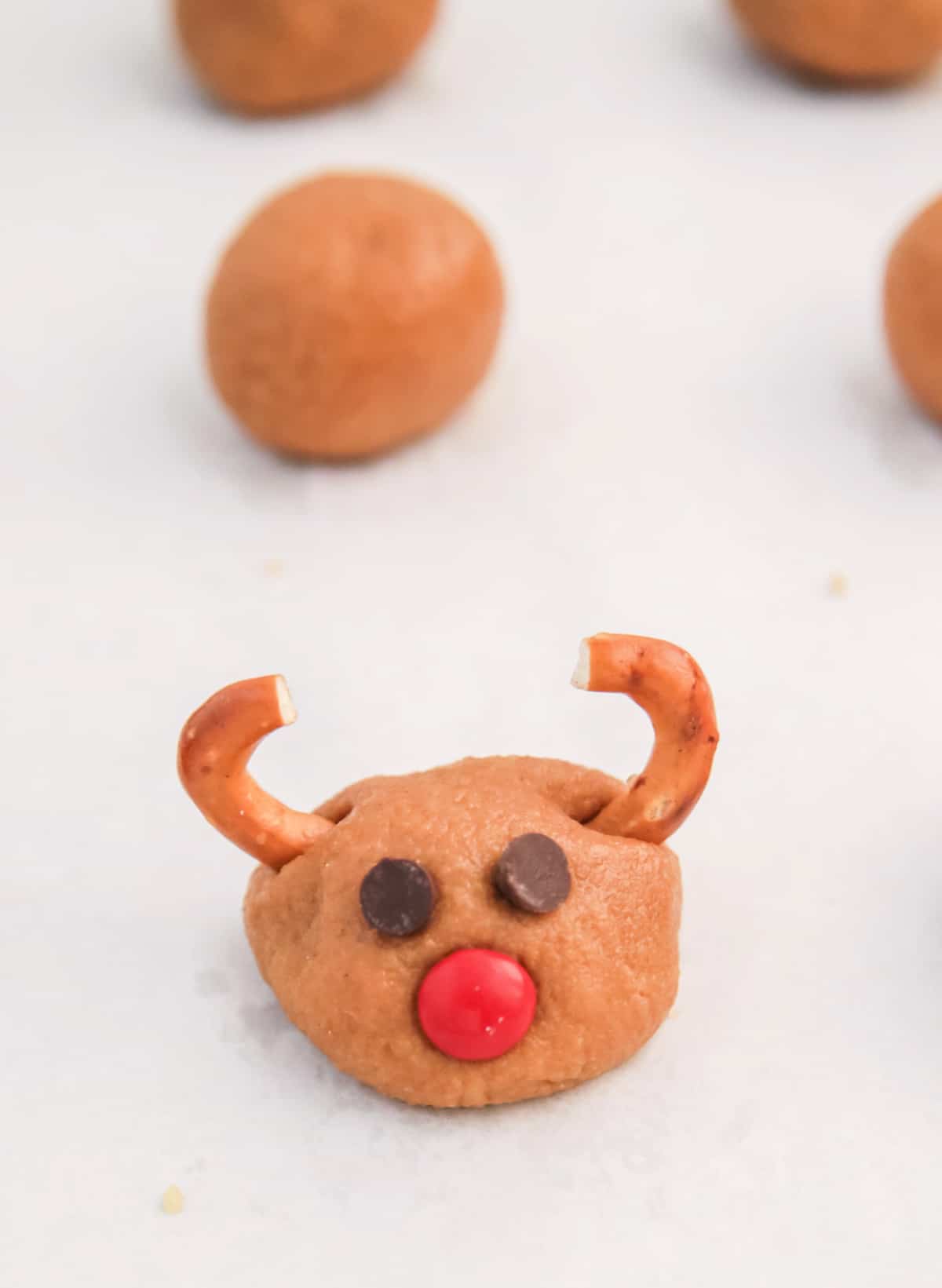 Add eyes, nose, and antlers to cookie balls. 