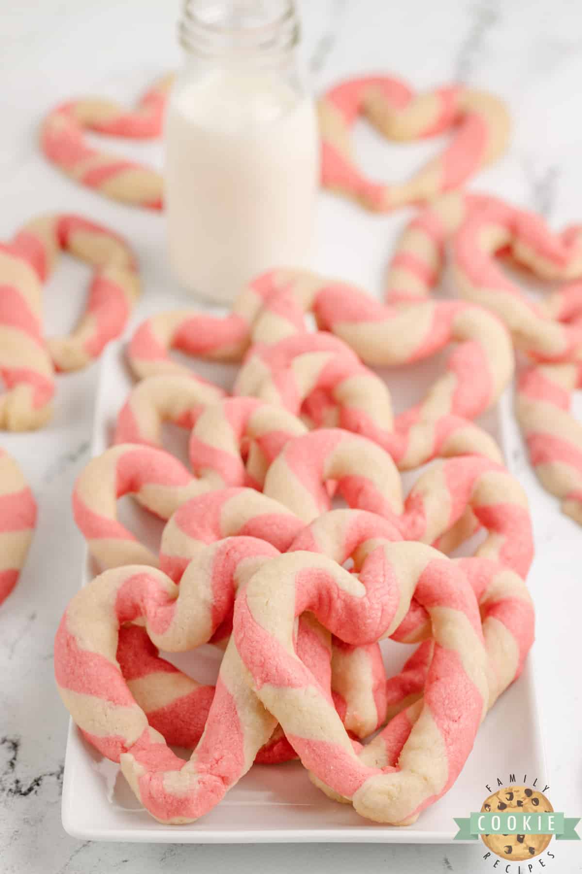 Braided Sweetheart Cookies are simple sugar cookies formed into pink and white striped hearts. These heart-shaped cookies are easy to make and are so pretty, you don't even need frosting!