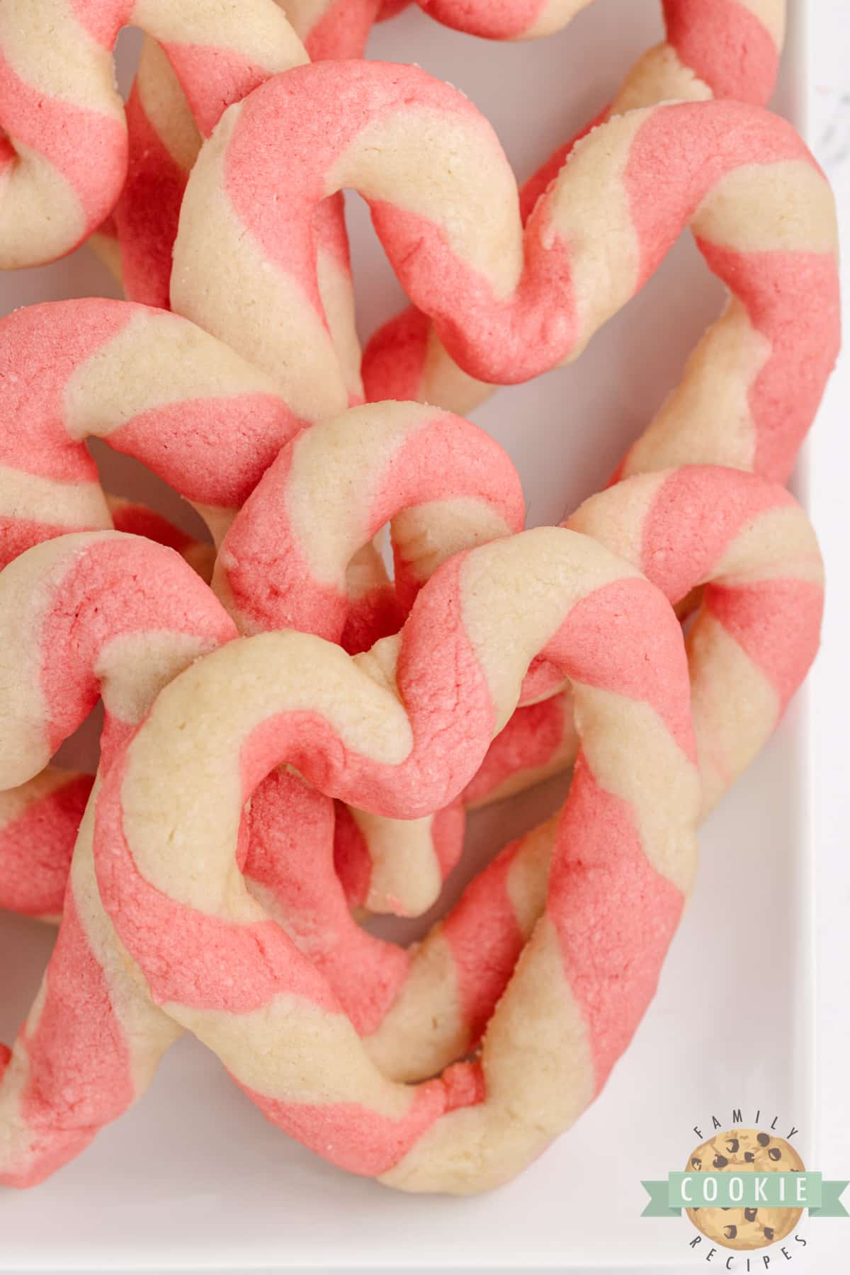 Braided Sweetheart Cookies are simple sugar cookies formed into pink and white striped hearts. These heart-shaped cookies are easy to make and are so pretty, you don't even need frosting!