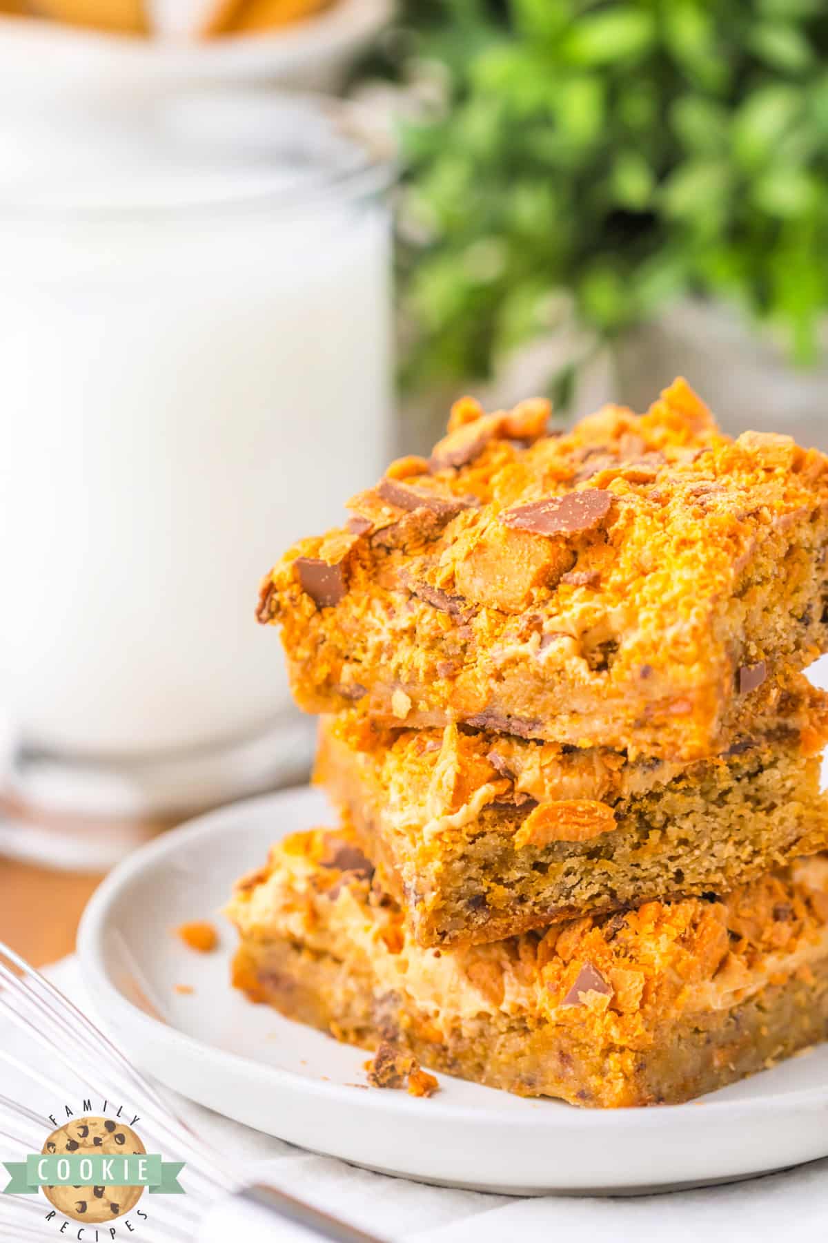 Butterfinger Cookie Bars begin with a soft and chewy blondie cookie base that is topped with peanut butter frosting and crushed Butterfinger candy bars. 