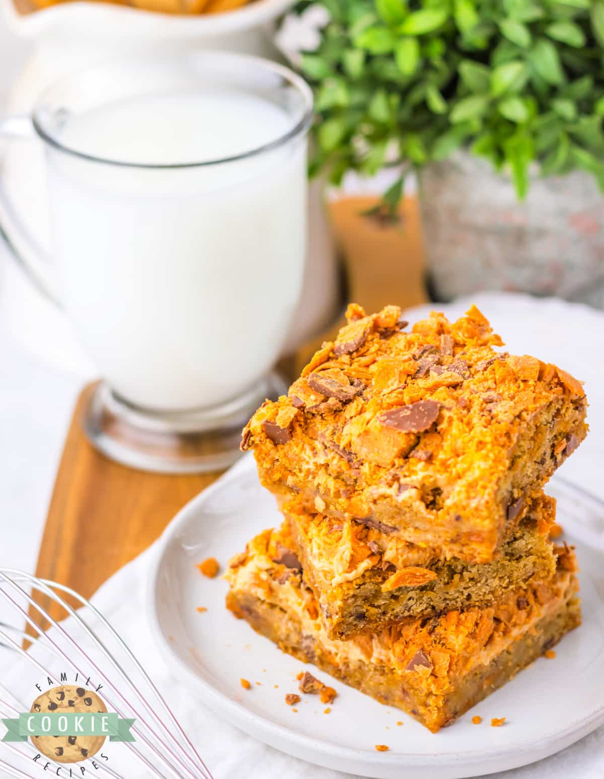 Butterfinger Cookie Bars begin with a soft and chewy blondie cookie base that is topped with peanut butter frosting and crushed Butterfinger candy bars. 