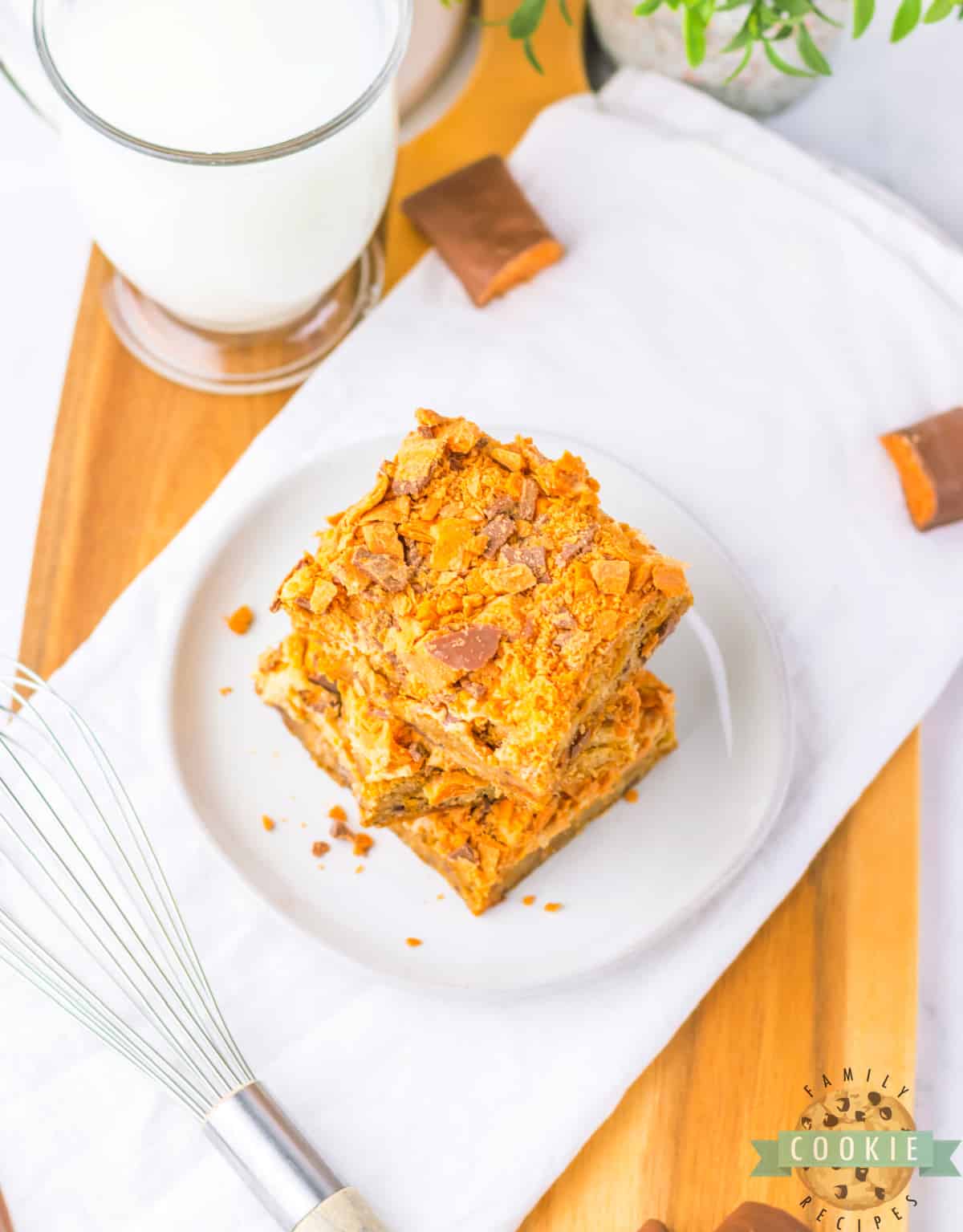 Butterfinger Cookie Bars begin with a soft and chewy blondie cookie base that is topped with peanut butter frosting and crushed Butterfinger candy bars. 