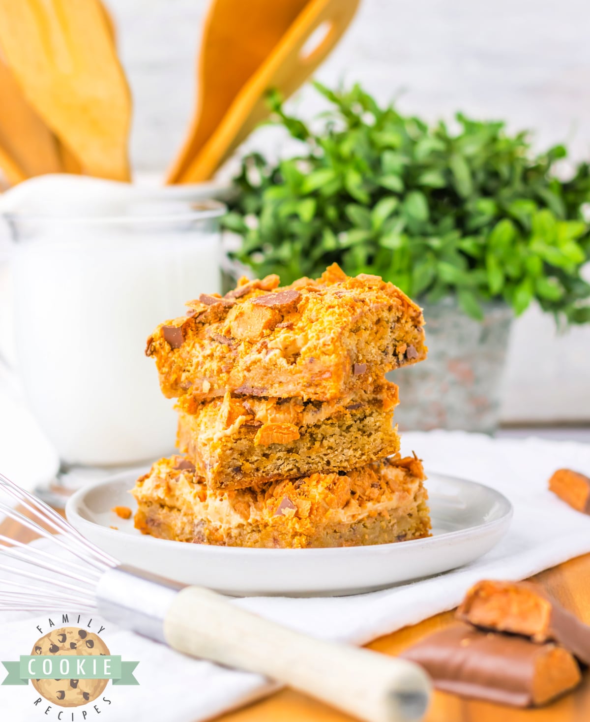 Cookie Bars with peanut butter frosting and crushed Butterfinger candy bars. 